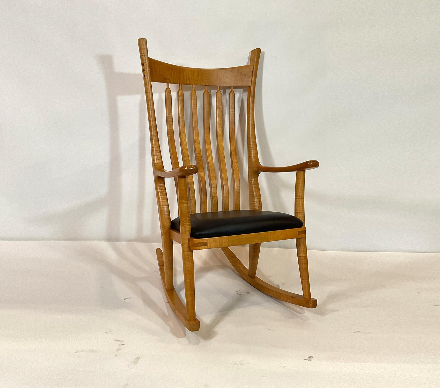 Custom-made rocking chair by an expert custom furniture maker. Graceful lines, excellent lumber with beautiful grains. Study the pictures. Marked with maker’s name. Leather seat cover.

Weight: 28 LBS
Overall Dimensions: 47” H x 25” L x 31”