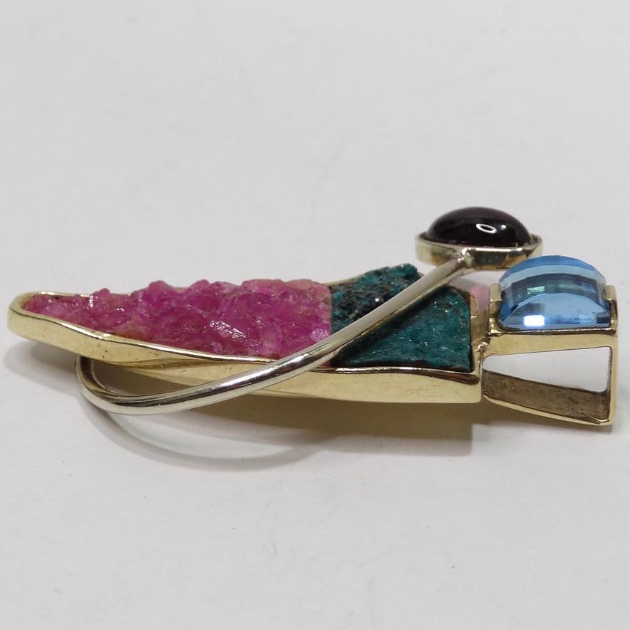 Attention all Africa lovers! This large abstract 1980s pendent is calling your name! Beautiful vintage multicolor pendent compromised of large blue topaz and pink tourmaline stones alongside 14K yellow gold come together in a beautiful shape of the