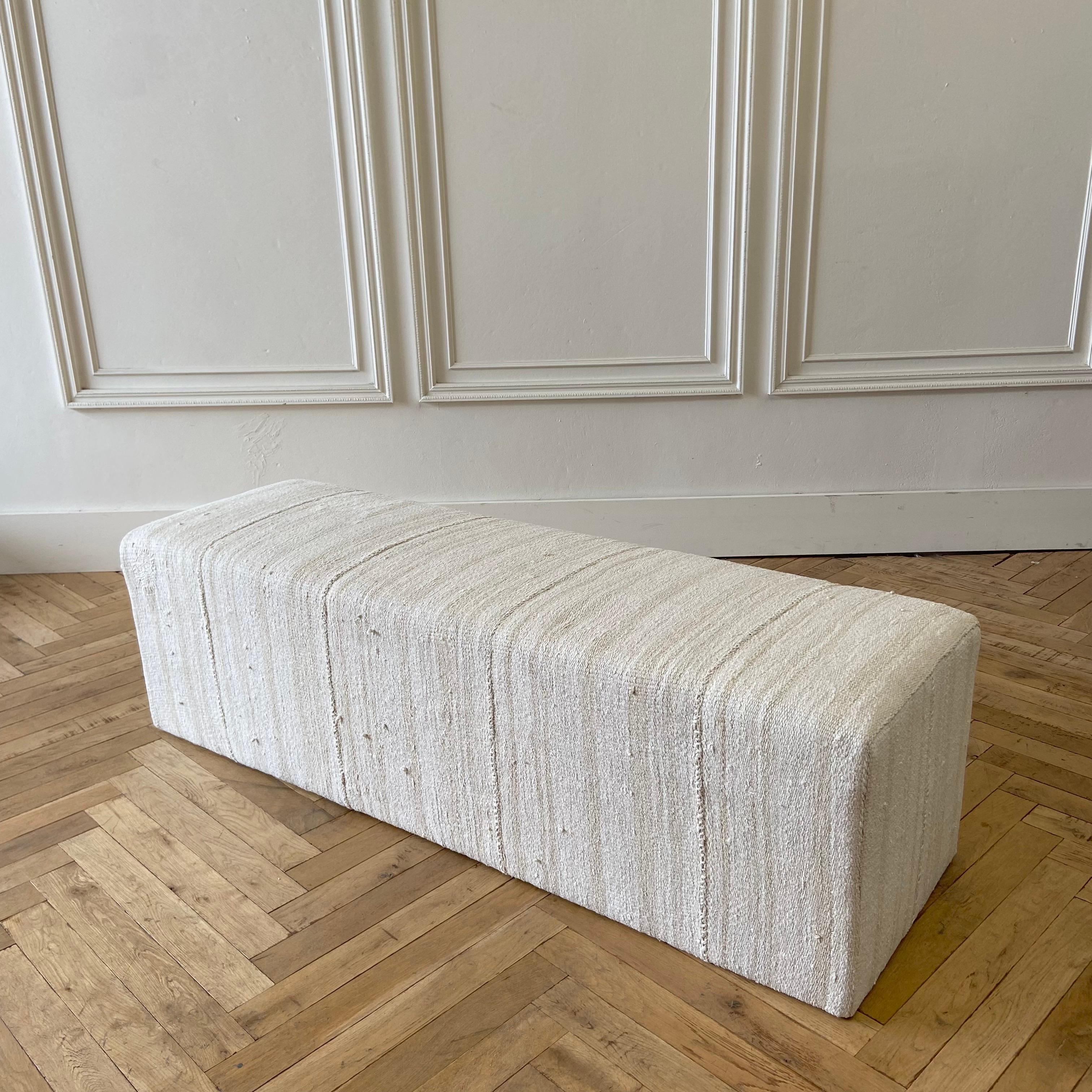 Beautiful Custom MadeCube ottoman 
Size: 60”W X 18”D X 18”H
Made from a vintage turkish hemp and wool rug, in an off white, with faded stripes.
The stripes are faded taupe/brown, and can appear as a dijon coloring in some lights.
Original seams,