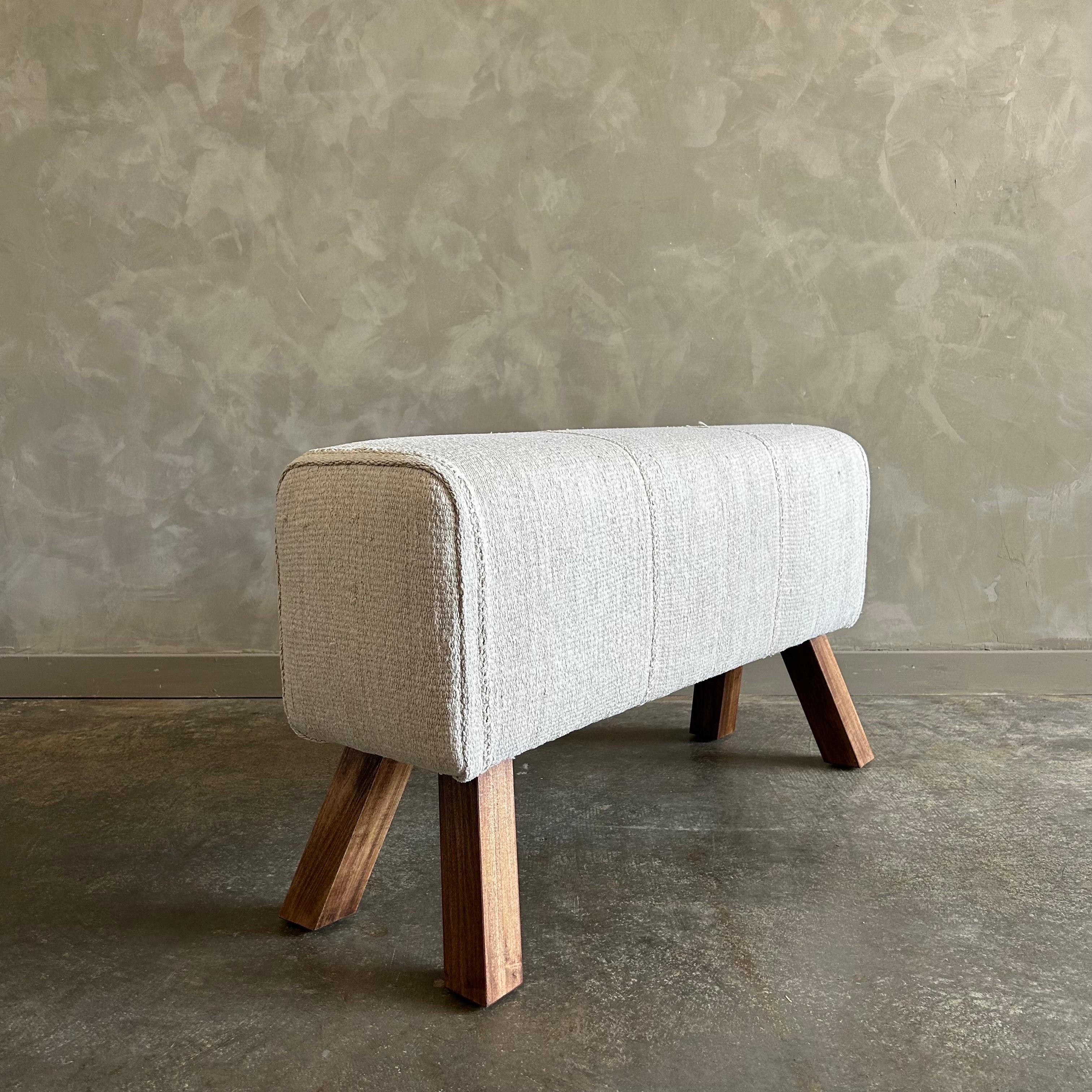 Pommel horse 40”w x 13”d x 22”h
Custom made from a vintage hemp rug, in an oyster white color.
The legs are alder in a medium stain finish.
Original seams shown, add character and uniqueness to this bench.
Color: oat / white
Custom sizes can be