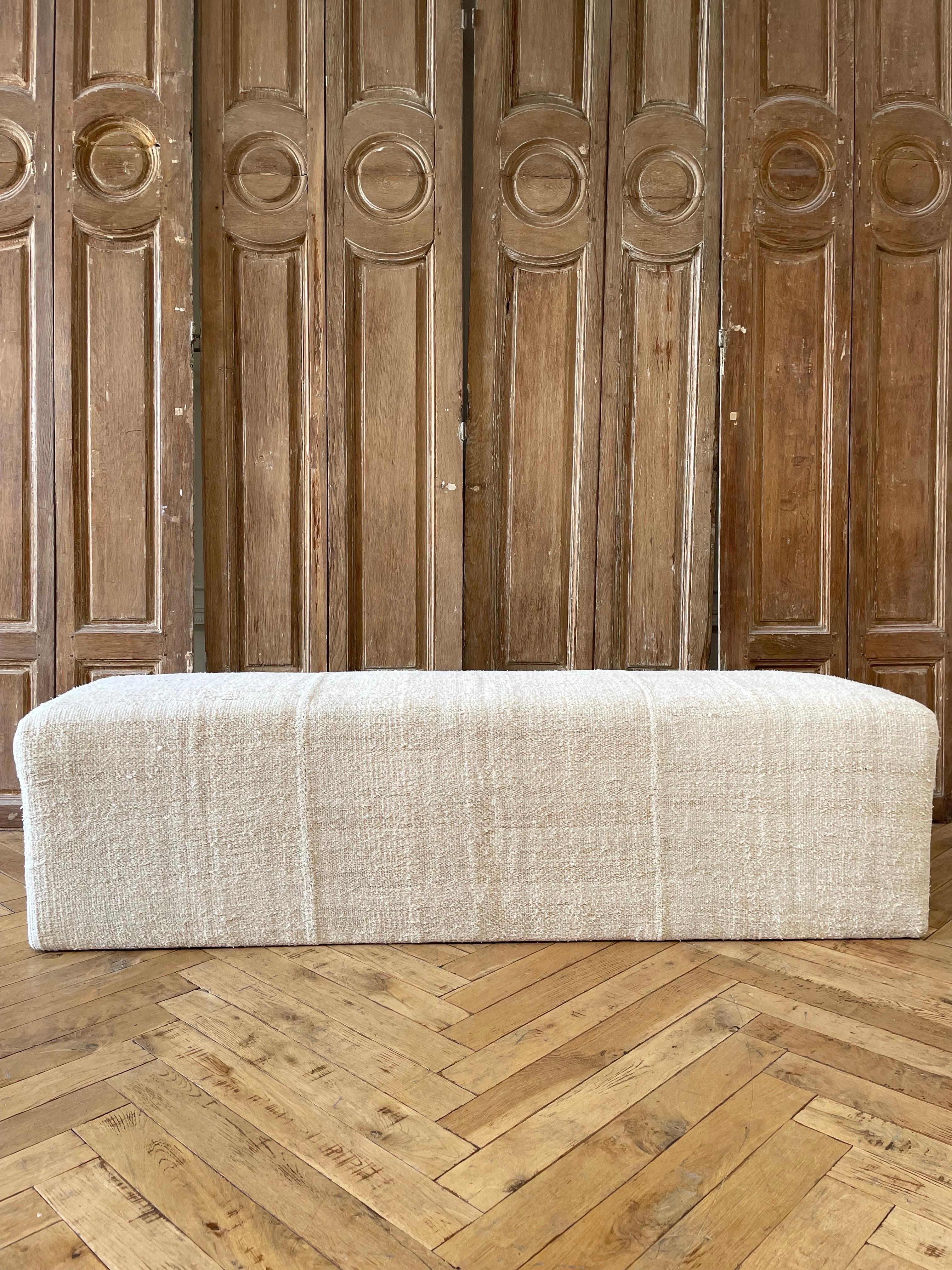 Beautiful Custom MadeCube ottoman. Made from a vintage turkish hemp and wool rug, in an off white, with faded stripes. The stripes are really faded taupe/brown, and can appear as a dijon coloring in some lights. Original seams, sewn with an overlock