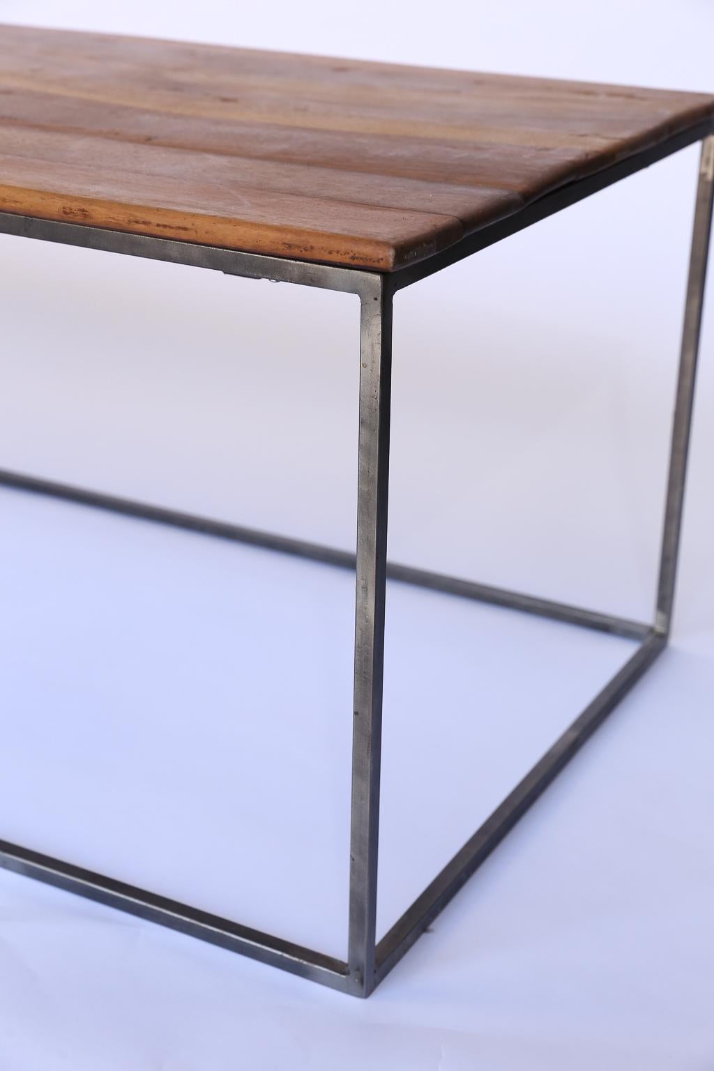 This sleek and modern custom made coffee table offers function and form. The classic combination of wood and iron will add warmth and texture to any setting and a great way to start or finish your living room decor. The reclaimed walnut has a lovely