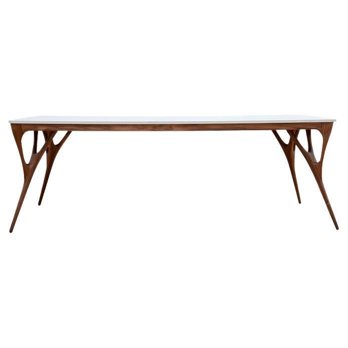 This dining table is a quadruped and branched design, with a light and stony horizontality. Its long legs turn this dining table into a dream.
Organic-inspired table that reinterprets the vegetal fractality with its symmetrical legs that open like