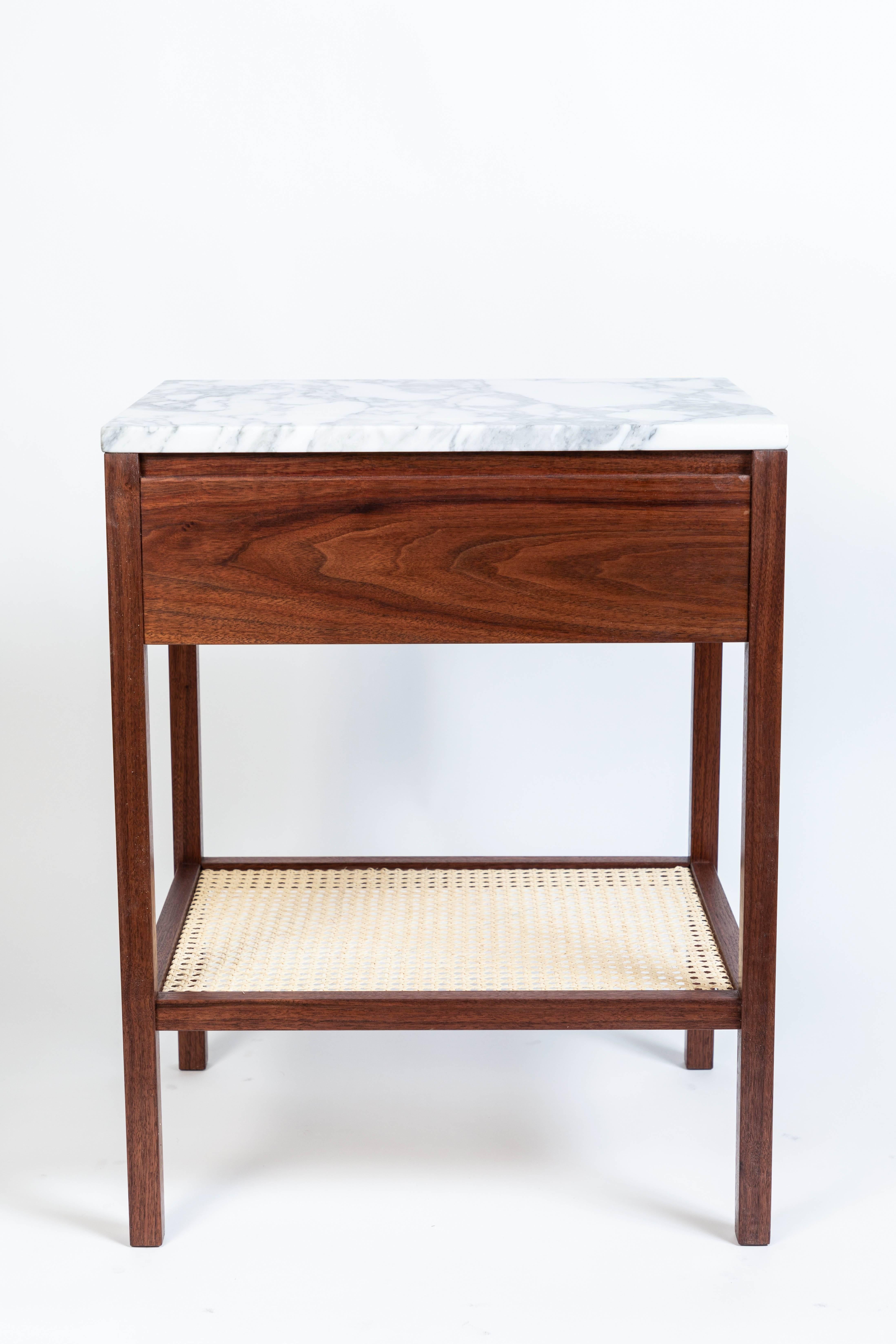 Custom-made nightstand or side table from solid walnut with a single drawer (interior drawer is maple), caned bottom shelf and white and gray marble top. 

Drawer hardware is oil rubbed bronze and brass. 

Dimensions may be slightly