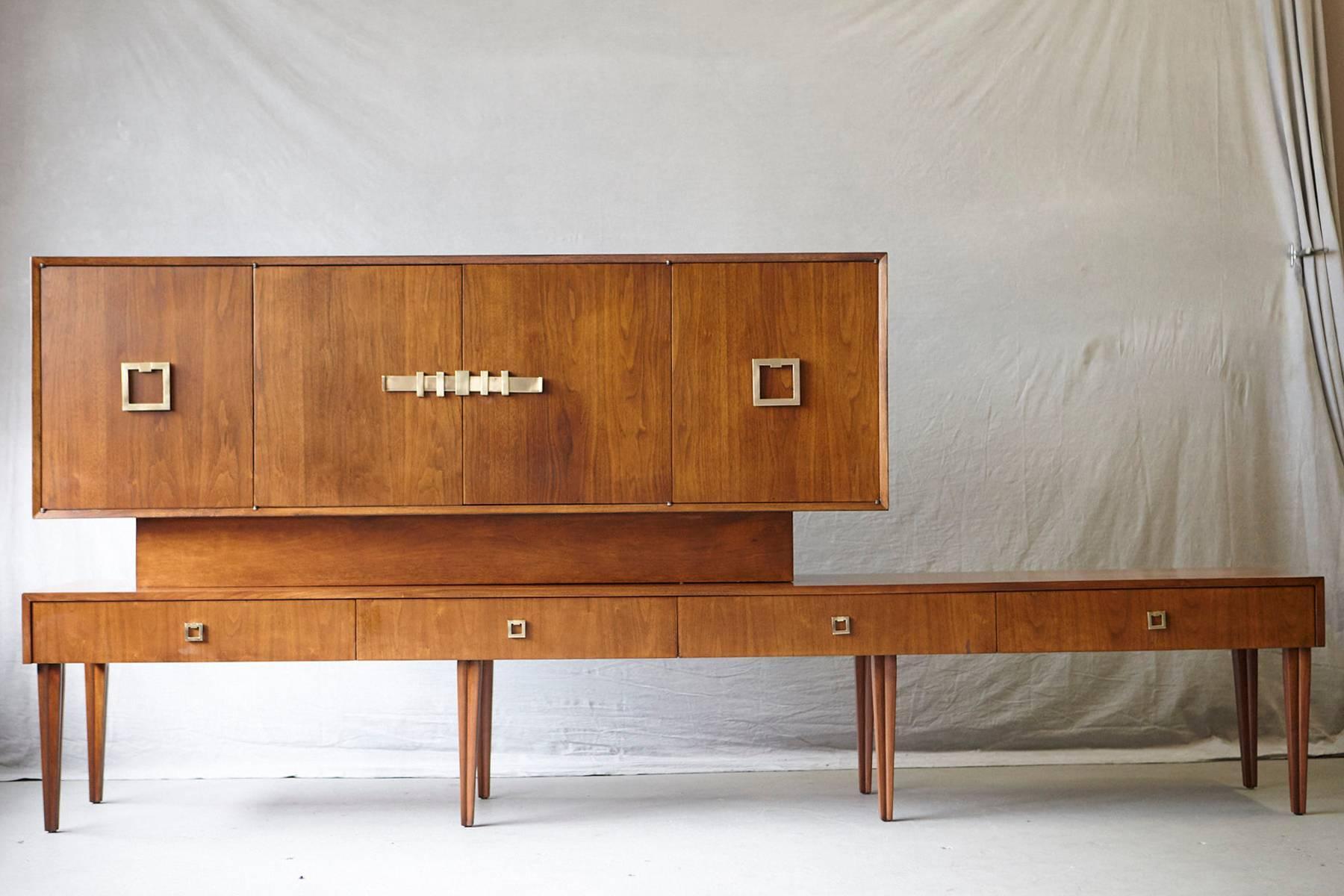Exceptional long custom-made walnut sideboard or credenza on eight reeded and tapered legs, circa 1940s.
Base with four drawers, one silverware drawer with lined felt and felt cover and another drawer also lined with felt. The top has four doors,
