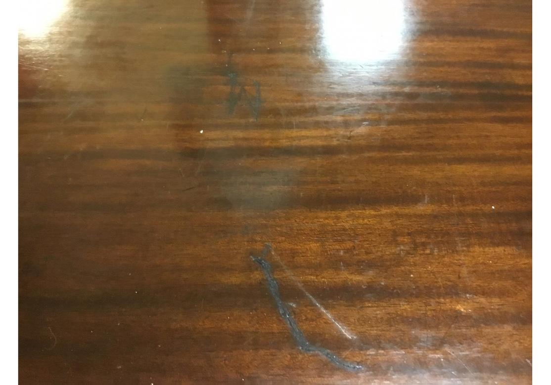 A long and very trim oval table with thin profile and handsome wood. Very well built with well turned legs. The table has some old scratches to the top which have been stained and polished over and a few missing veneer chips however the table