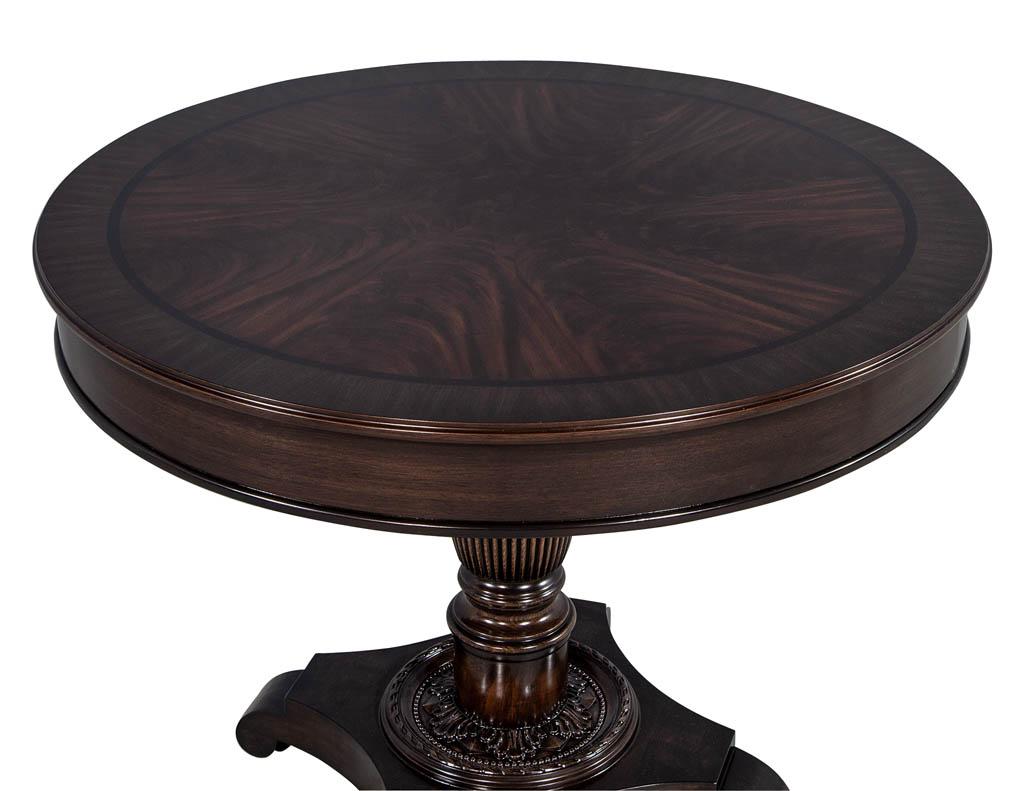 Carrocel Custom made traditional styled foyer table, with a flame mahogany center, walnut banded top with ebony inlay and sculpted and turned pedestal base.