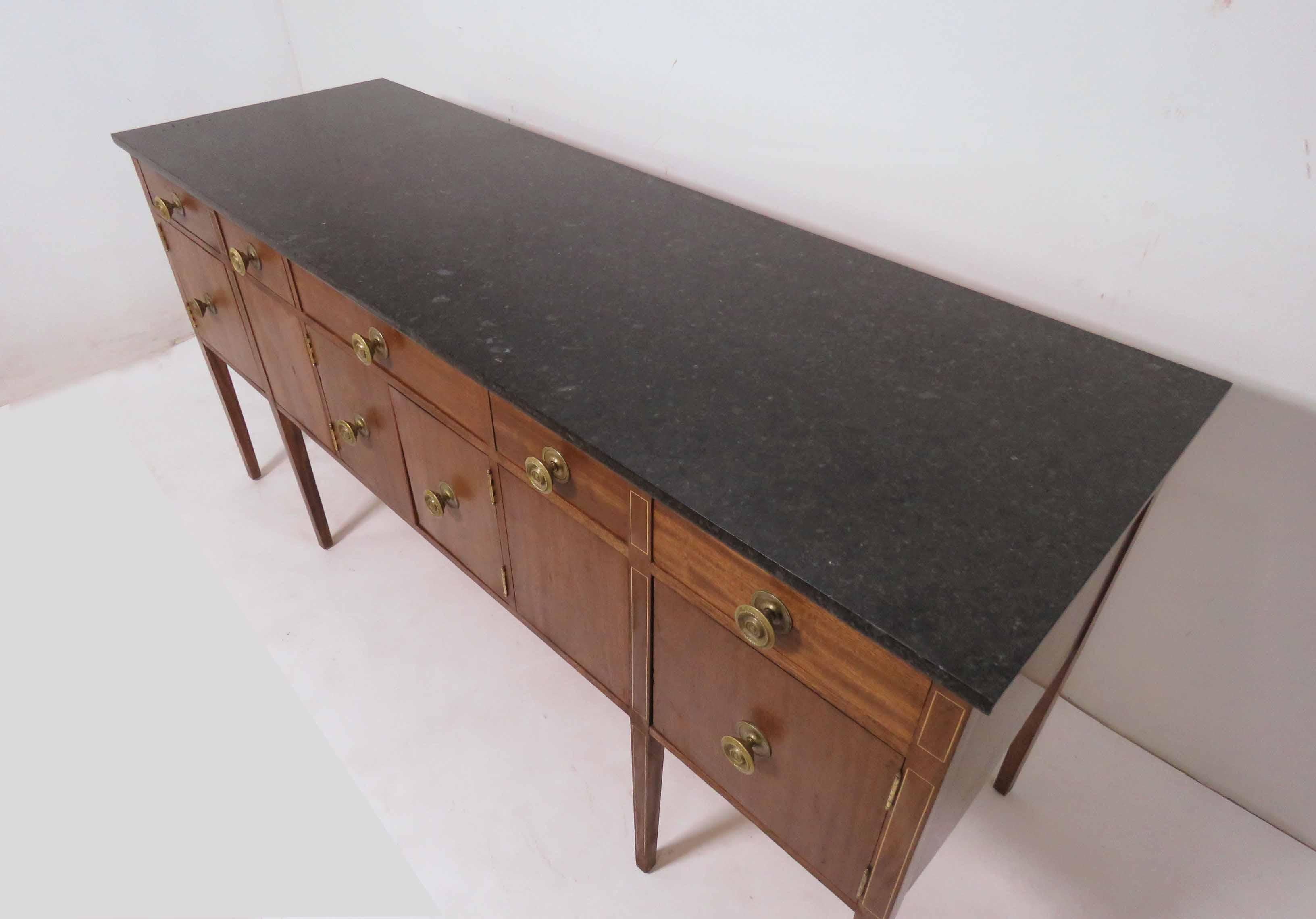 A wonderfully modern revision of the Sheraton style - a handmade sideboard in solid mahogany with polished granite top by master craftsman John Bueti, circa 1995. Bueti is a well respected cabinet maker whose work has been featured in the magazine
