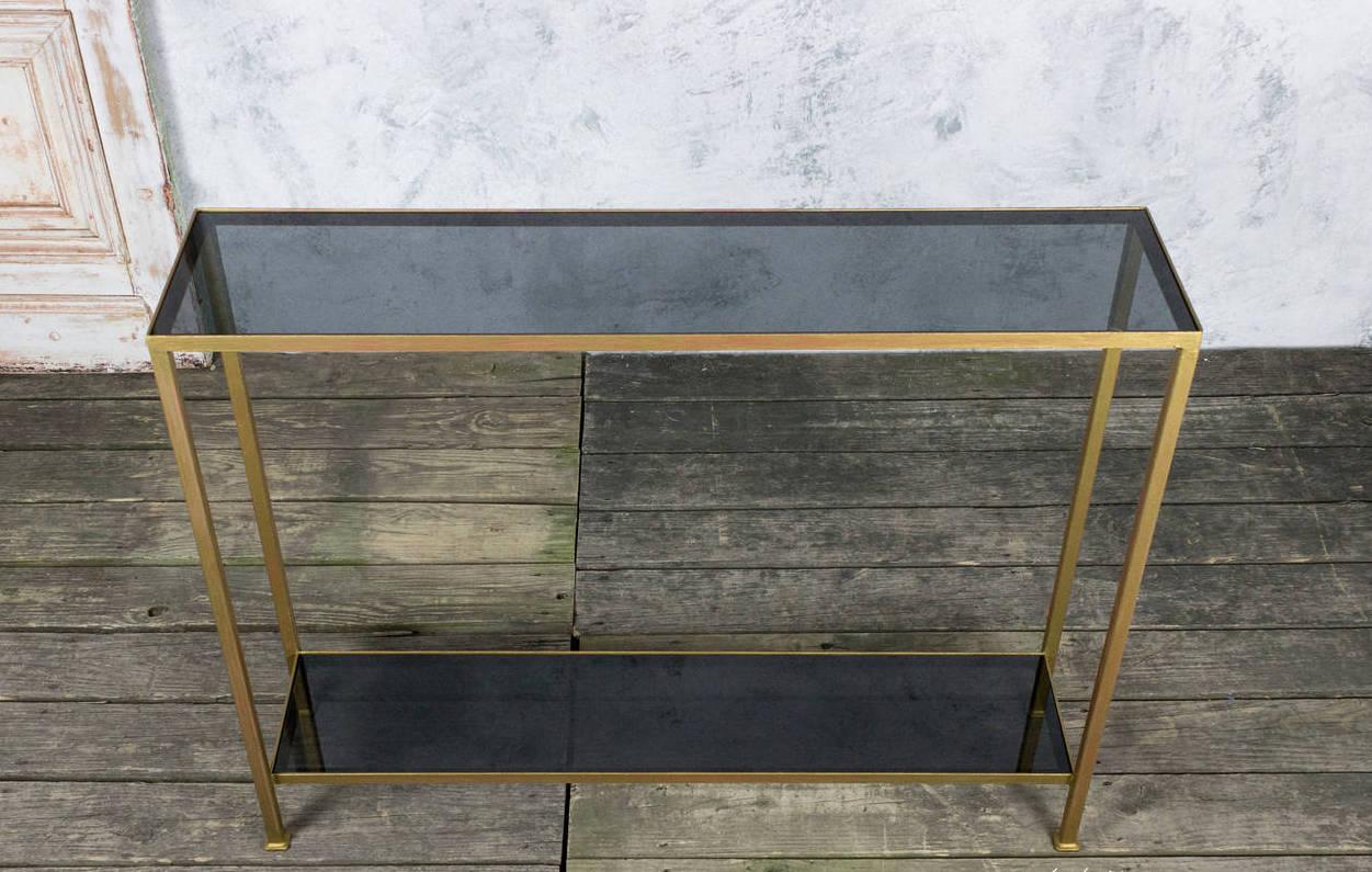 This striking console features an iron frame in a distressed gold finish with ½