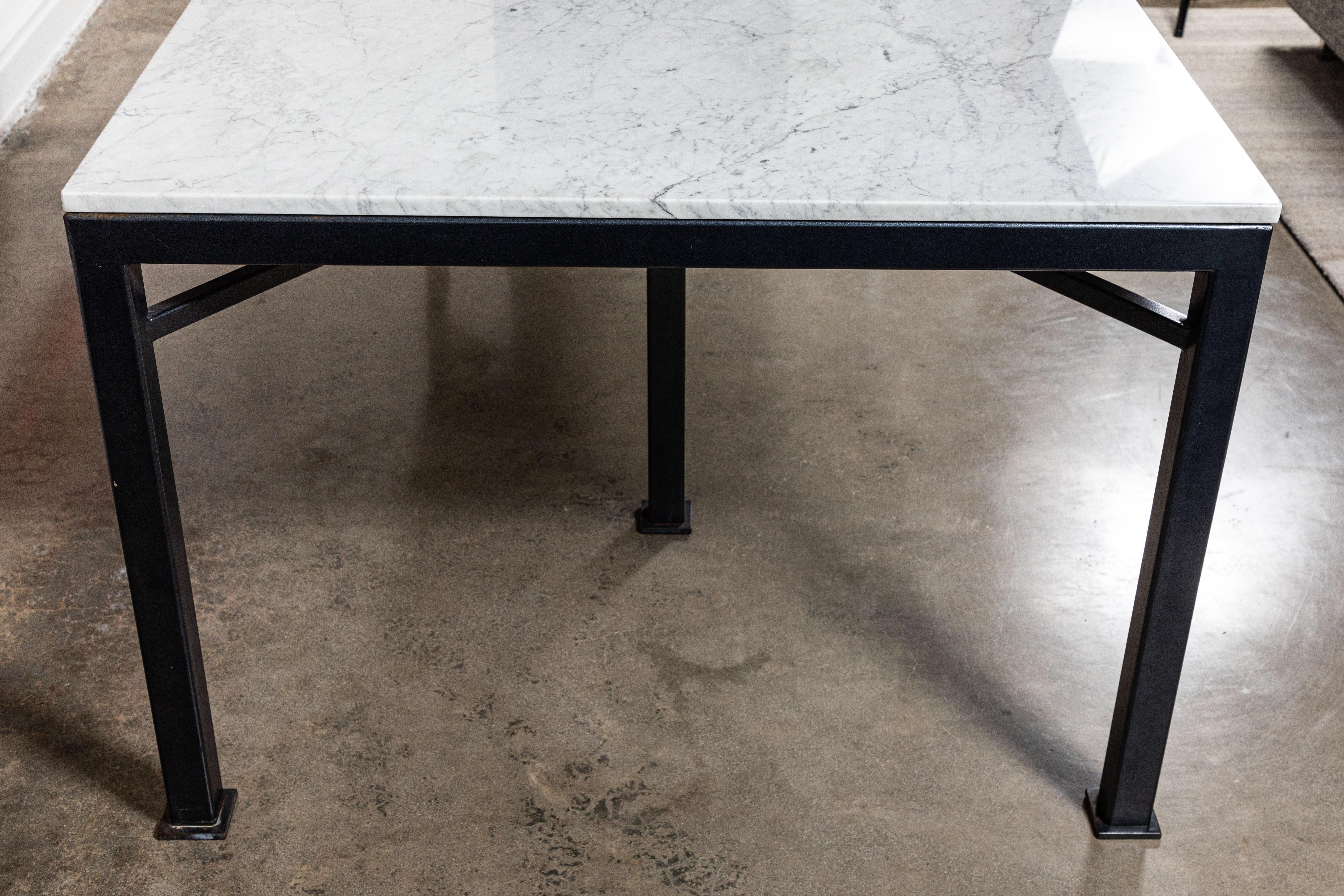 Massive custom made iron and Carrara marble dining table. Designed and fabricated by On Madison, this table was featured in a grand Pasadena estate. The base has been powder-coated in a gunmetal gray finish. The Carrara marble top is in excellent