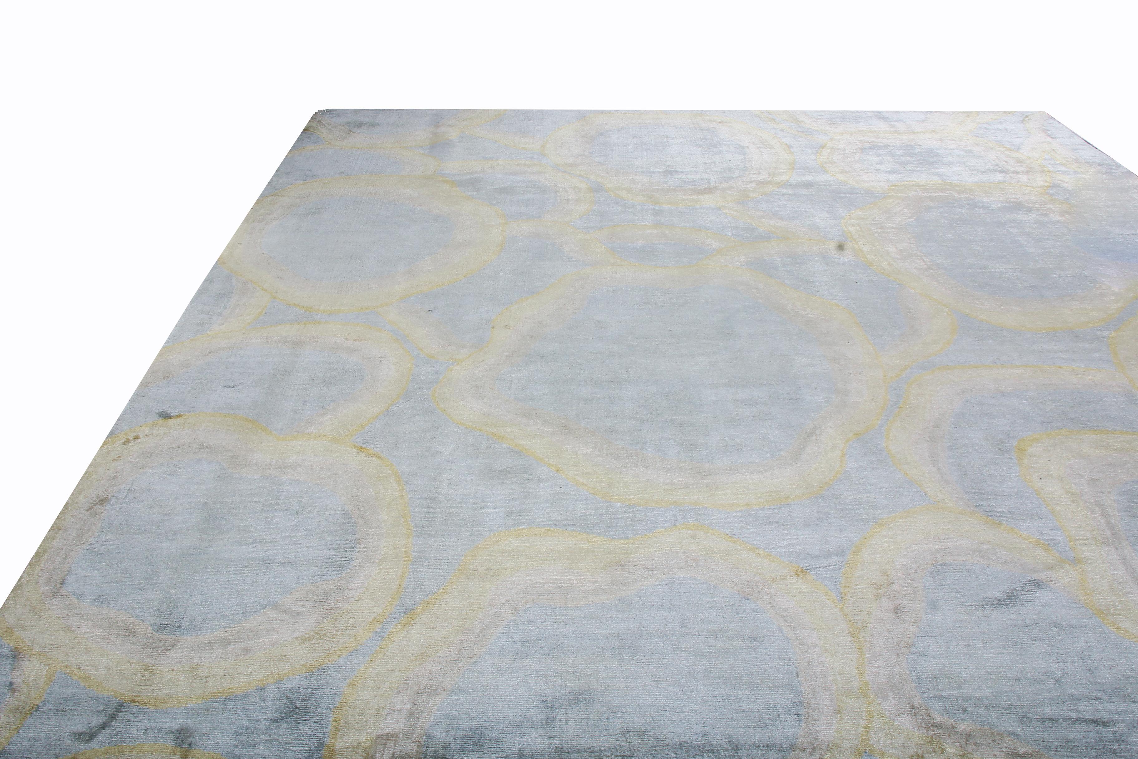 Rug & Kilim’s “Bubbles” rug hails from its newly unveiled custom collection, featuring a lustrous, abrash background of Industrial, metallic gray with titular golden-yellow bubbles in hand knotted Matka silk; available in full custom sizes.
 
