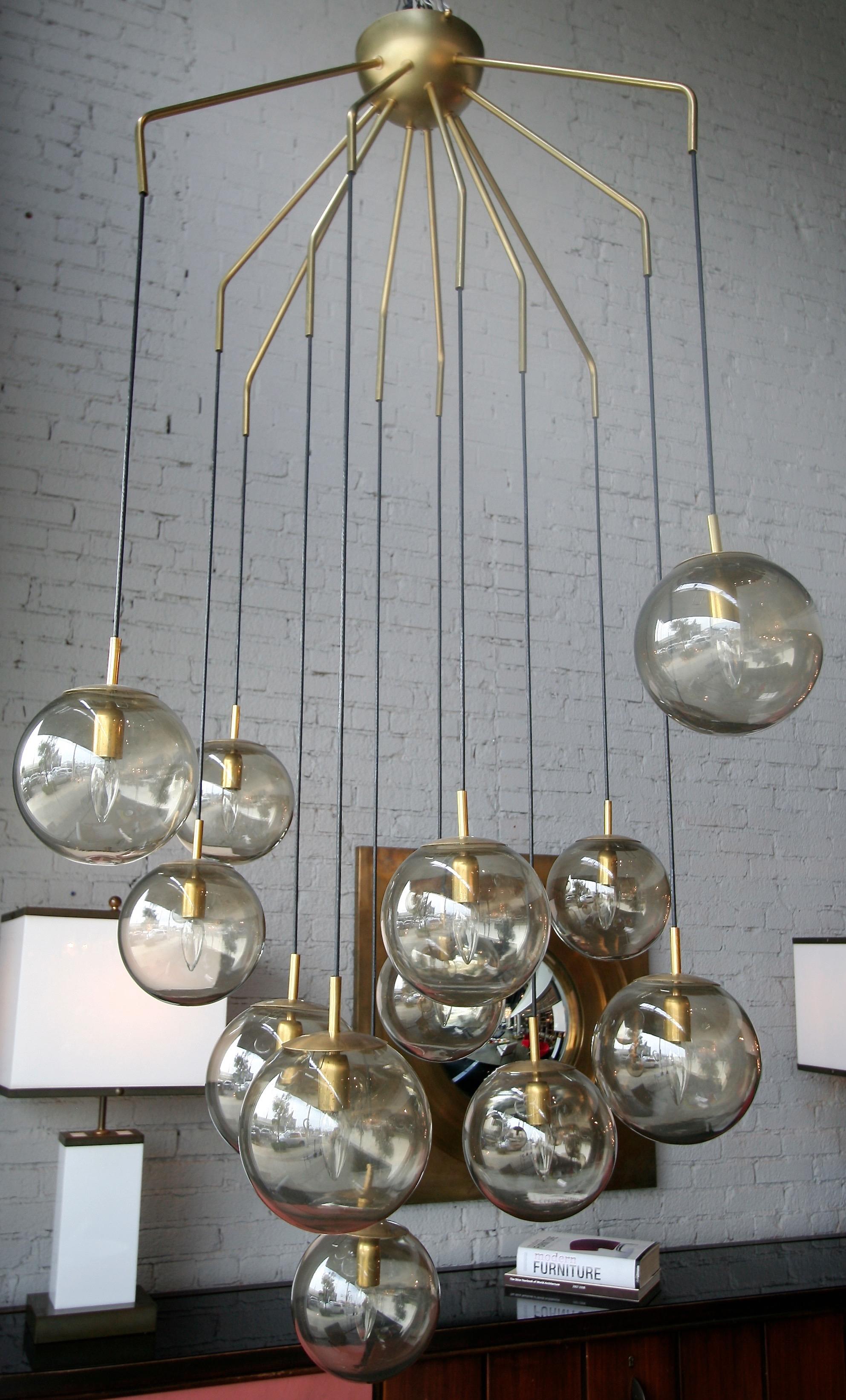 Custom Murano Mid-Century Modern style chandelier with 12 cascading smoked glass balls. Shipping from Italy not included in price.

 