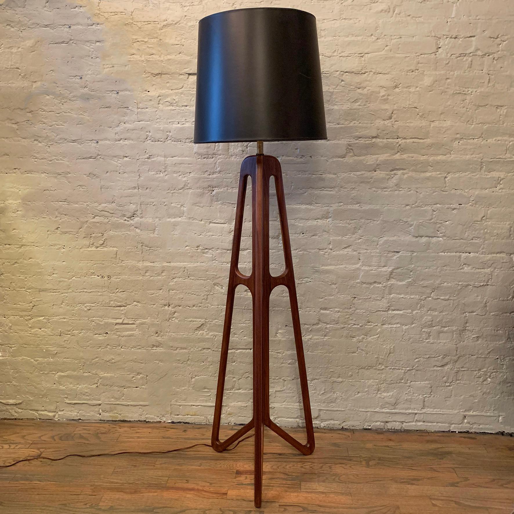 Custom, Mid-Century Modern style, floor lamp features a sculpted, solid walnut, butterfly base with brass neck, harp and finial measuring 50.5 inches to the top of the neck. The lamp is custom made in Brooklyn by City Foundry for our CF Signature.