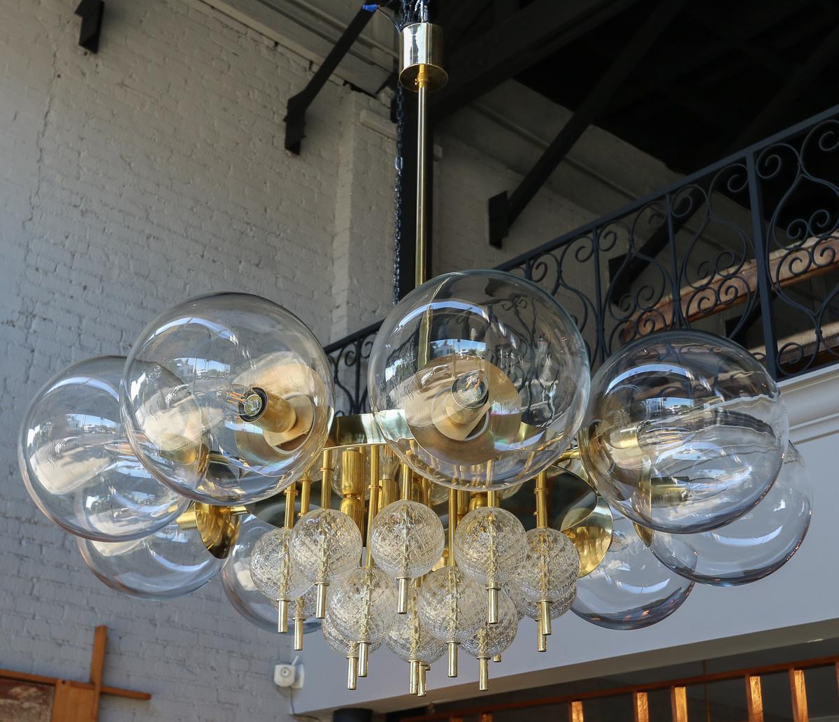Custom midcentury style chandelier with brass frame and an outer ring of clear glass balls and inner ring of textured clear glass balls by Adesso Imports. Can be done in different sizes and finishes.