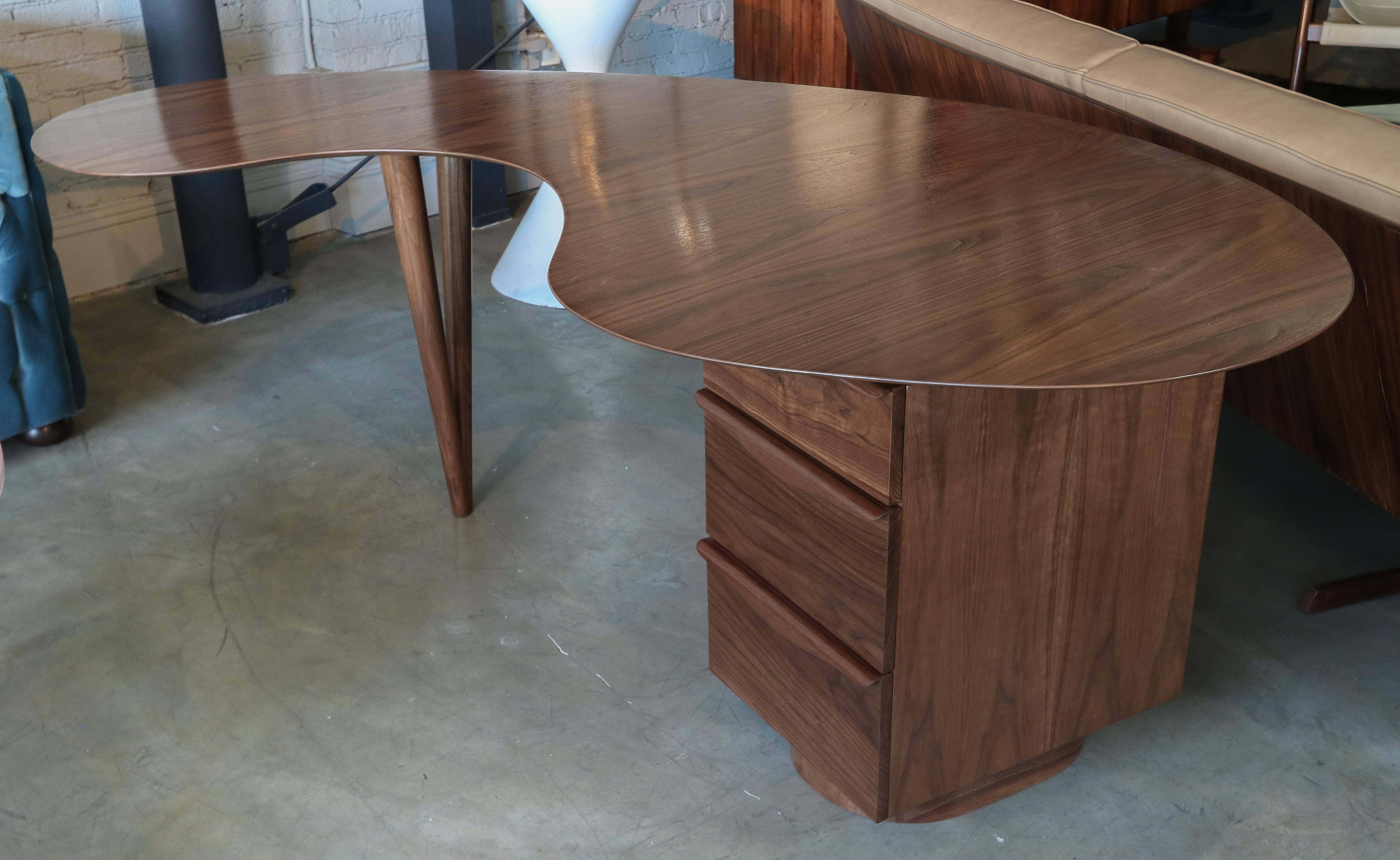 Custom midcentury style curved kidney shaped American walnut desk with three drawers.  Made in Los Angeles by Adesso Imports. Can be done in different woods and colors.