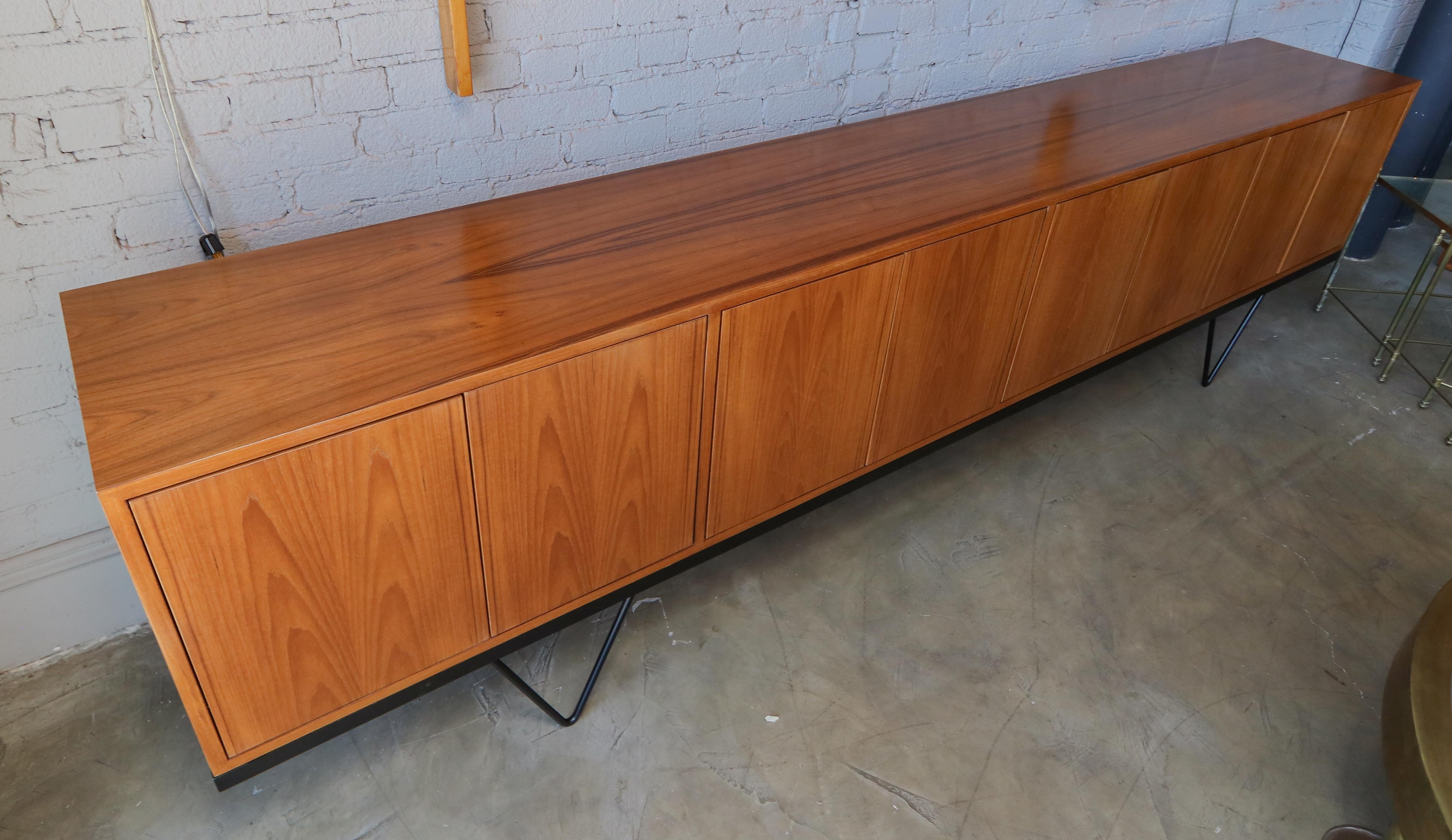 Custom midcentury style teak sideboard with black metal base. The four cabinets each have push latch doors with one adjustable shelf.  Made in Los Angeles by Adesso Imports.  Can be done in different sizes and woods. 