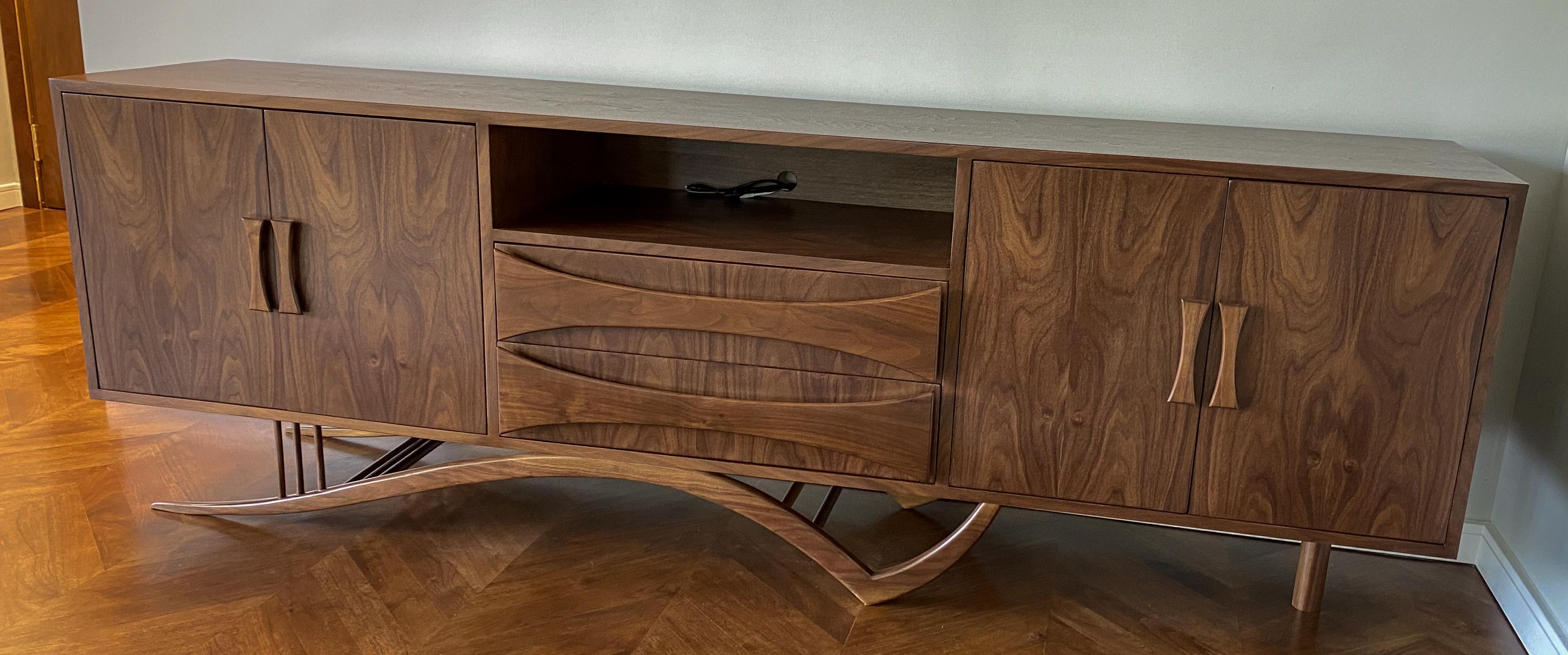 Custom midcentury style American walnut sideboard with elegant curved leg, two cabinets on either end and drawers in the middle and port to use as an entertainment center. Made in Los Angeles by Adesso Imports. Can be done in different sizes, woods