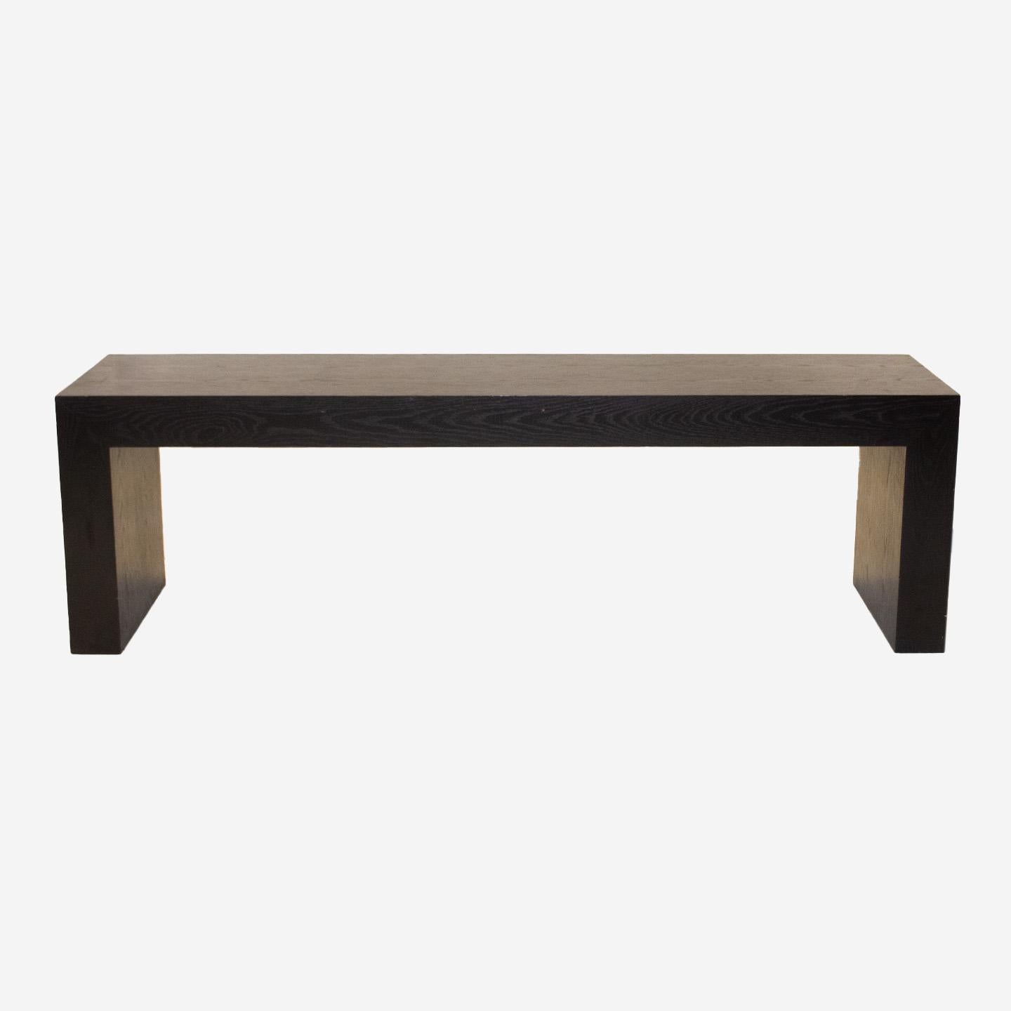 Elegant and boldly modern, this custom made Minimalist walnut bench is made in the USA, c. 1980. With its sleek and sophisticated lines, this piece will also work well as a low console in any room where you need decorative counter surface. The grain