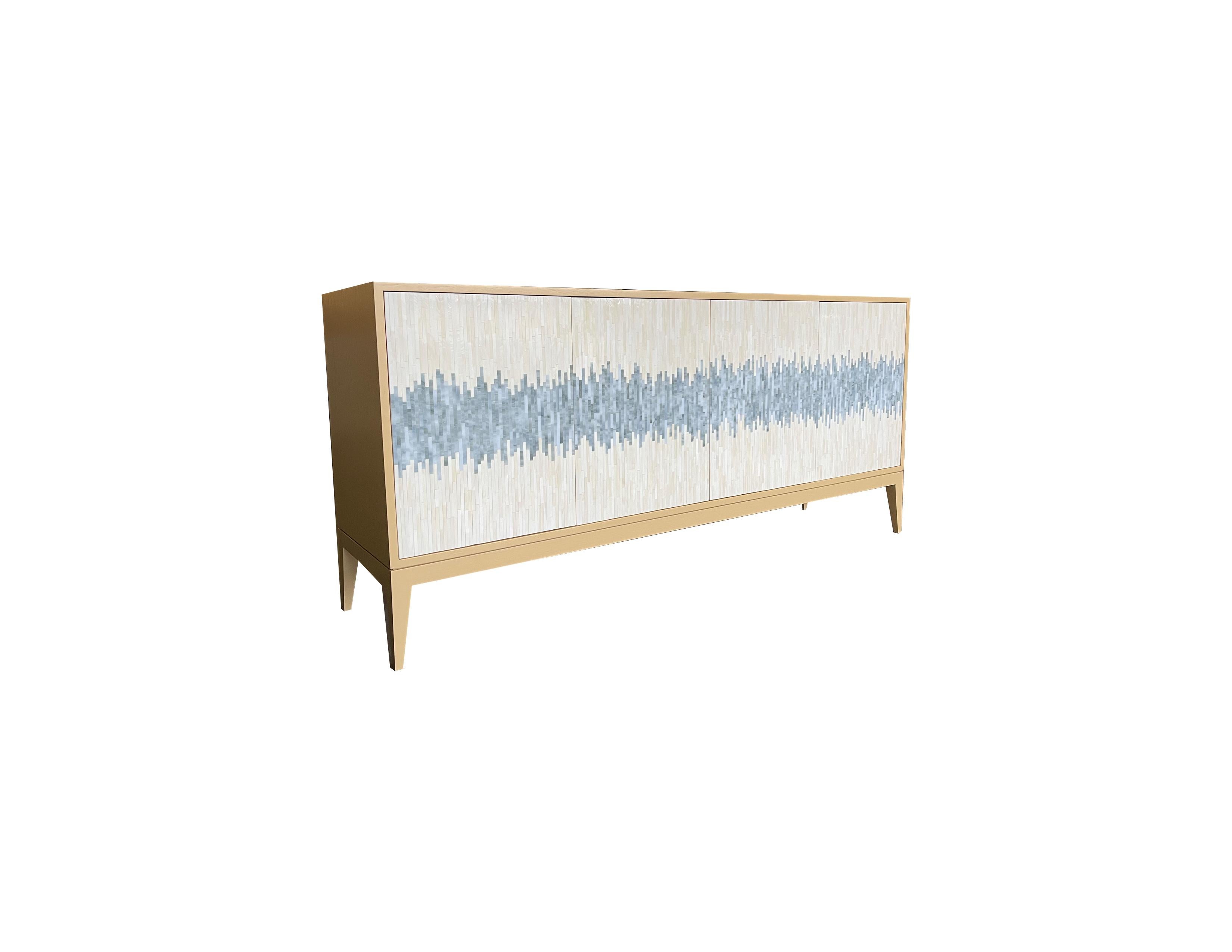 Our custom Milano 4 door wave buffet is a beautiful piece consisting of two compartments, 4 touch latch doors, and a Ercole Milano Wood Base. This Piece is finished in a custom Benjamin Moore paint that is a warm tan color. The glass wave pattern is