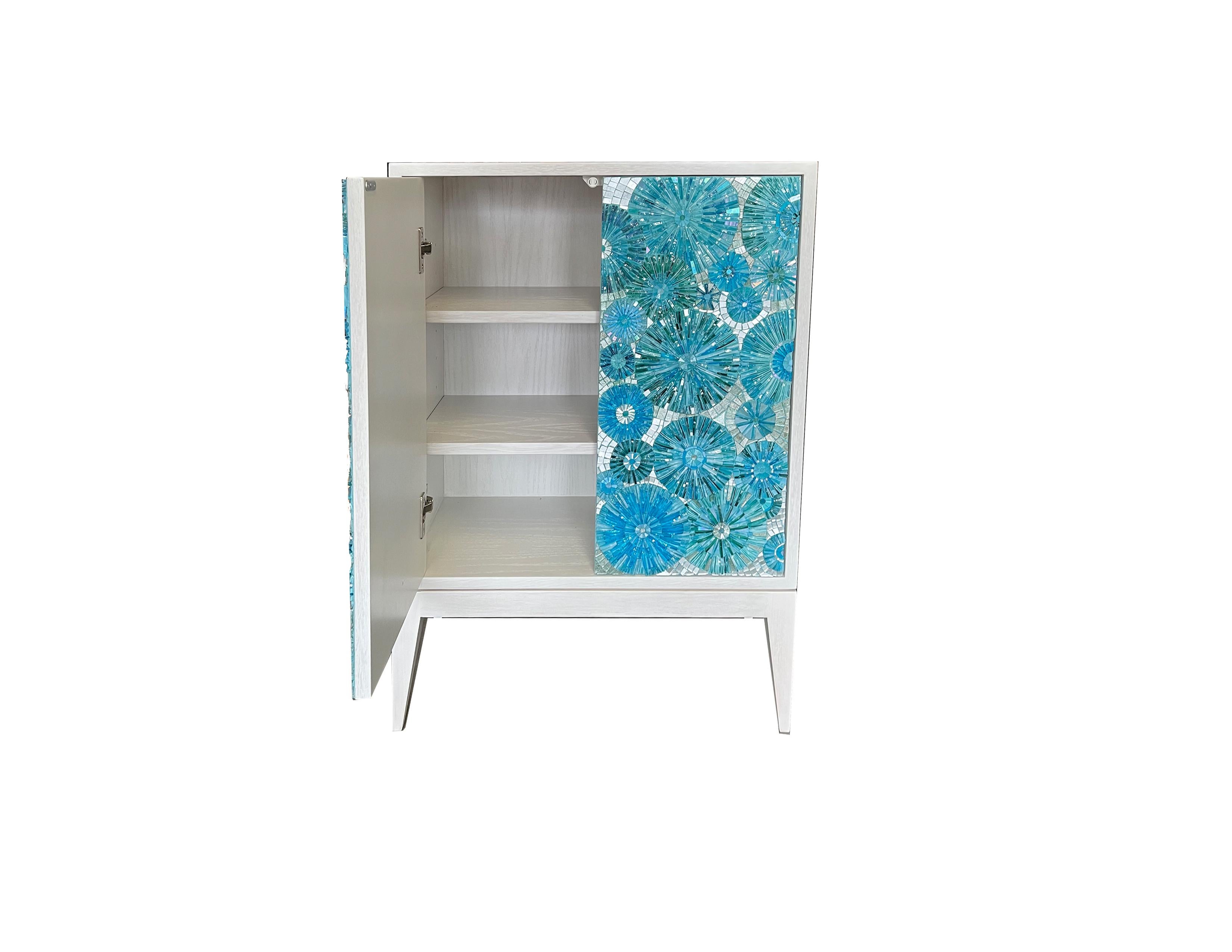 Our custom Blossom 2-door blossom cabinet is the perfect mini storage addition to any space! Consisting of one compartment with two adjustable shelves on its interior. The exterior is made up of our classic Milano legs in a soft washed-white wood