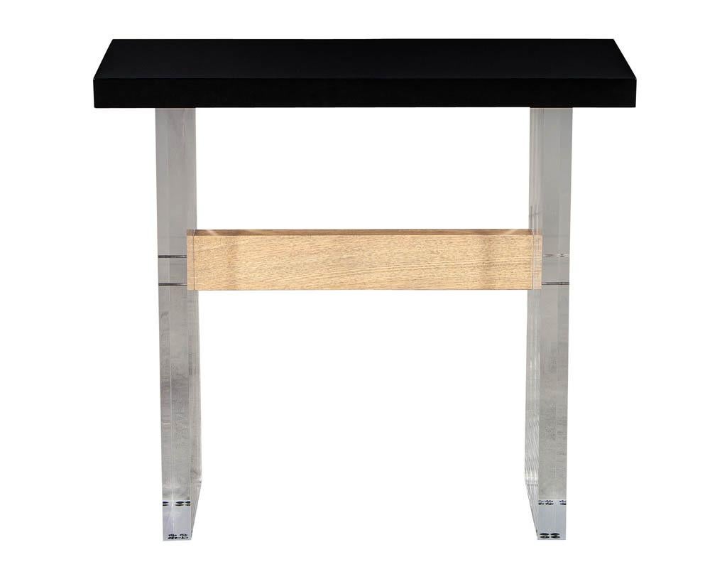 Custom modern acrylic console table by Carrocel. Custom made acrylic base console table with a hand polished black lacquered top and natural oak span. Acrylic is clear, photos show reflections of grey wall.

Price includes complimentary scheduled
