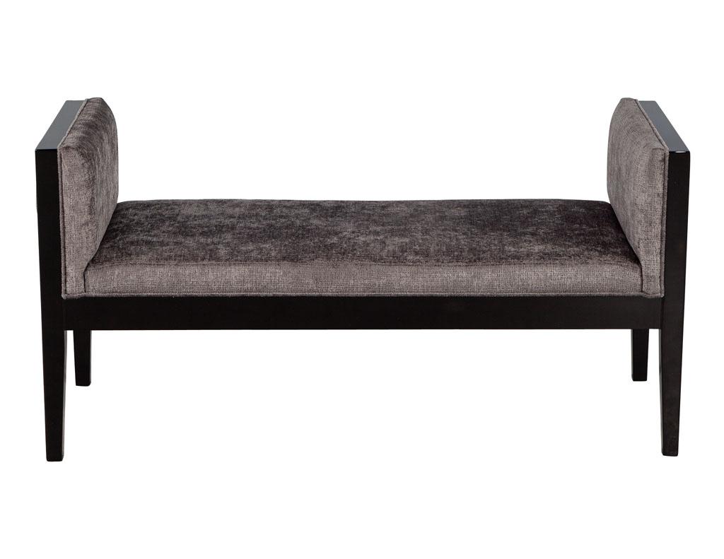 Custom Modern black lacquered bench. Simplistic modern design with tapered legs. Finished in a rich black lacquer with upholstered exterior side panels. Upholstered in a modern rustic dark fabric with thick seat cushion. Perfect accent piece for any