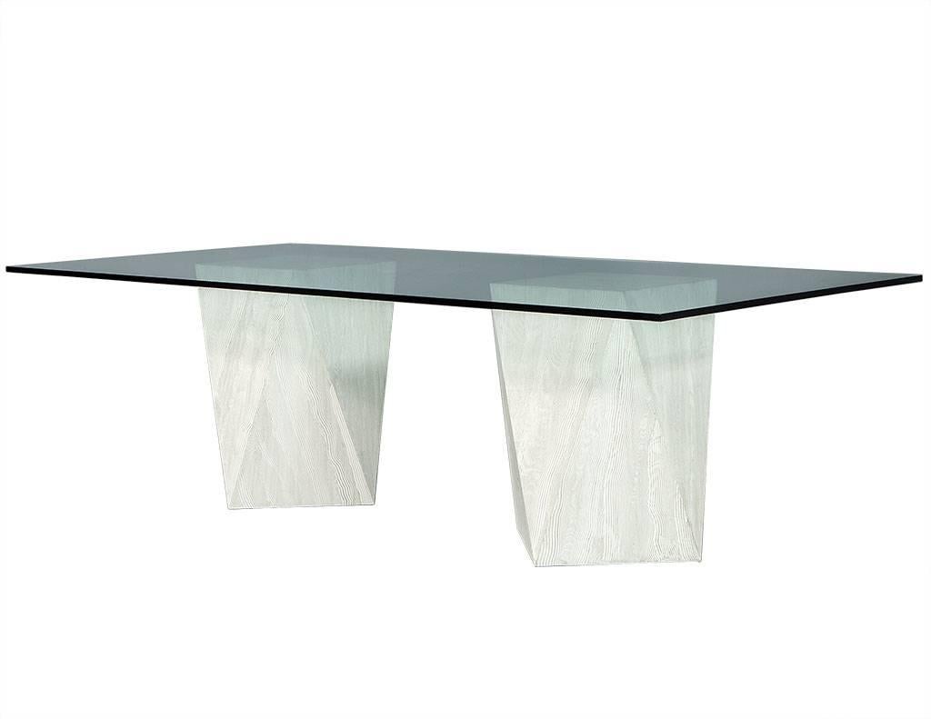 Custom modern geometric pedestals glass top dining table by Carrocel. Designed and built here at Carrocel, this modern dining table is totally chic. Composed of a double geometric pedestal base featuring a textured modern washed look with a thick