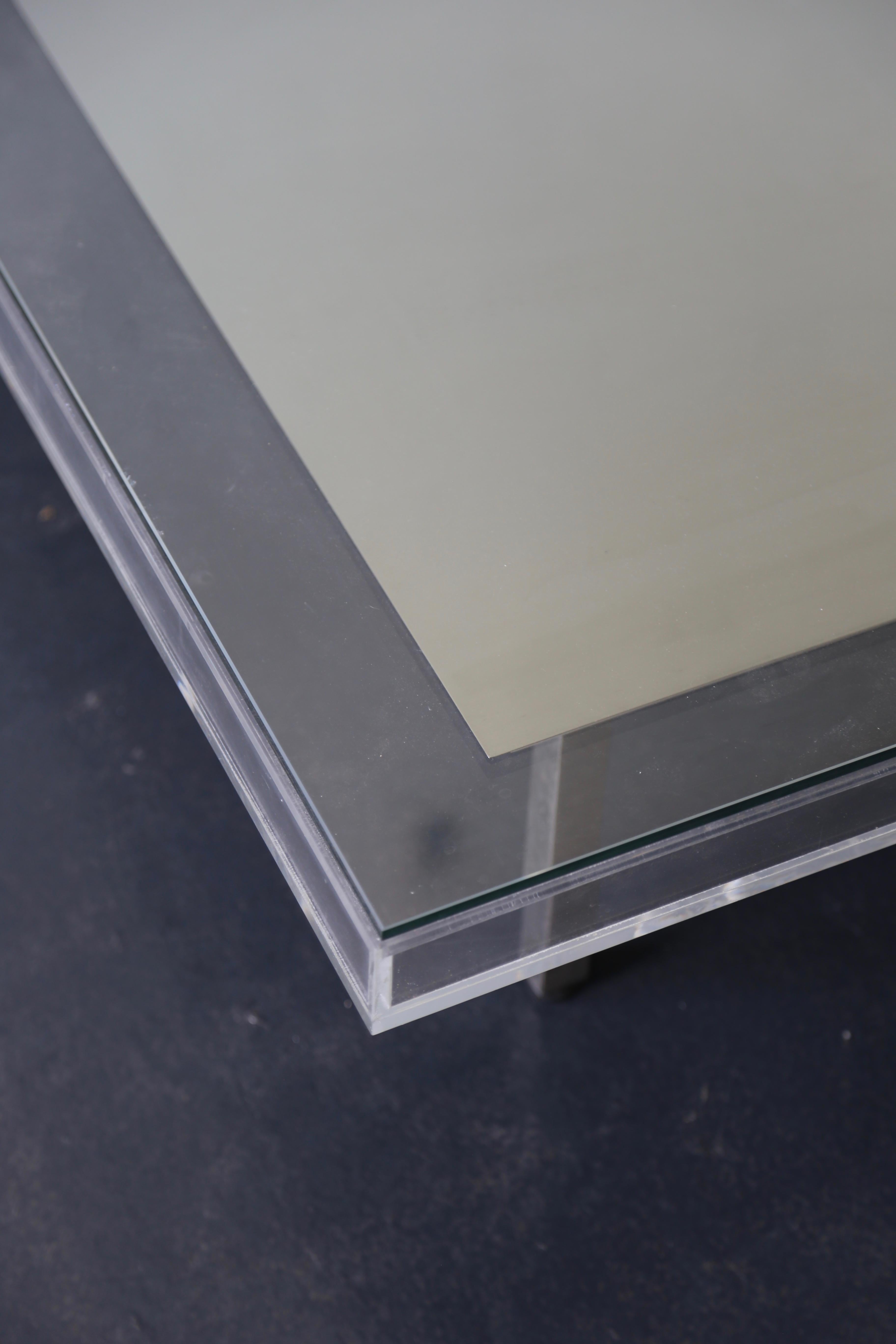 This modern and understated coffee table can act as a frame for whatever artwork you choose to display inside, or even loose pigment after Yves Klein. The structure is brushed steel and the top is glass but available in various metal finishes.  