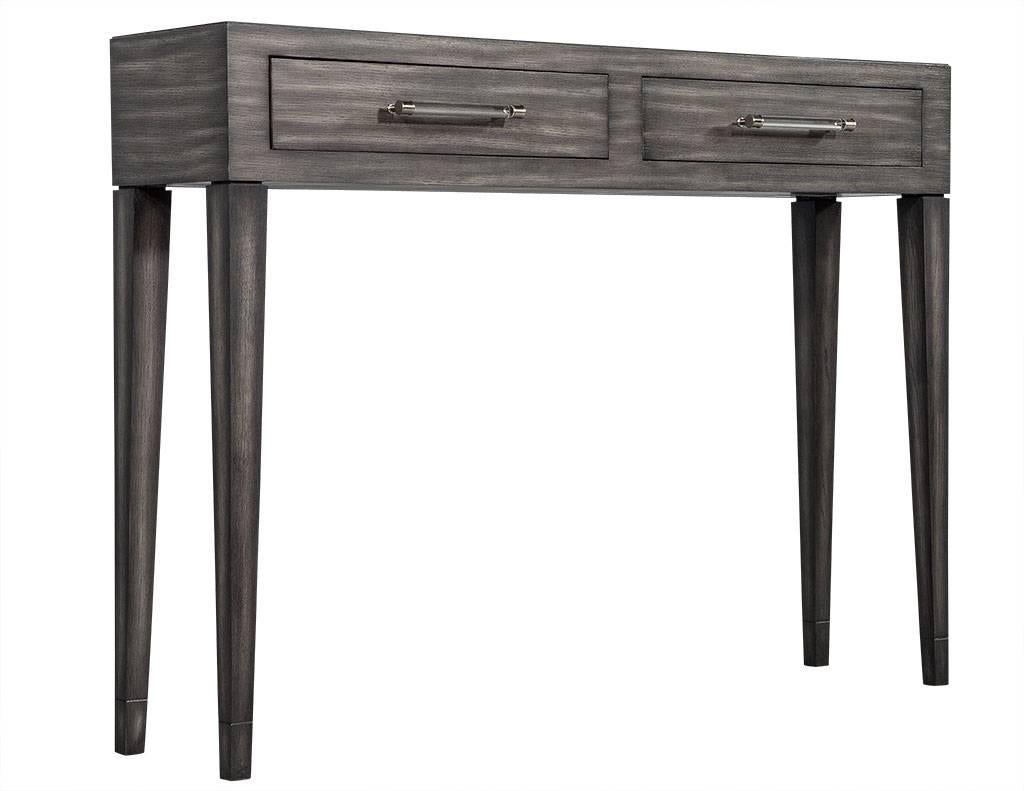 This Modern style console is composed of rift cut oak. Custom-made, it is finished in a warm gray with highlights throughout and two acrylic handles on each pull-out drawer. A beautiful piece perfect for any home. Hardware subject to change based on
