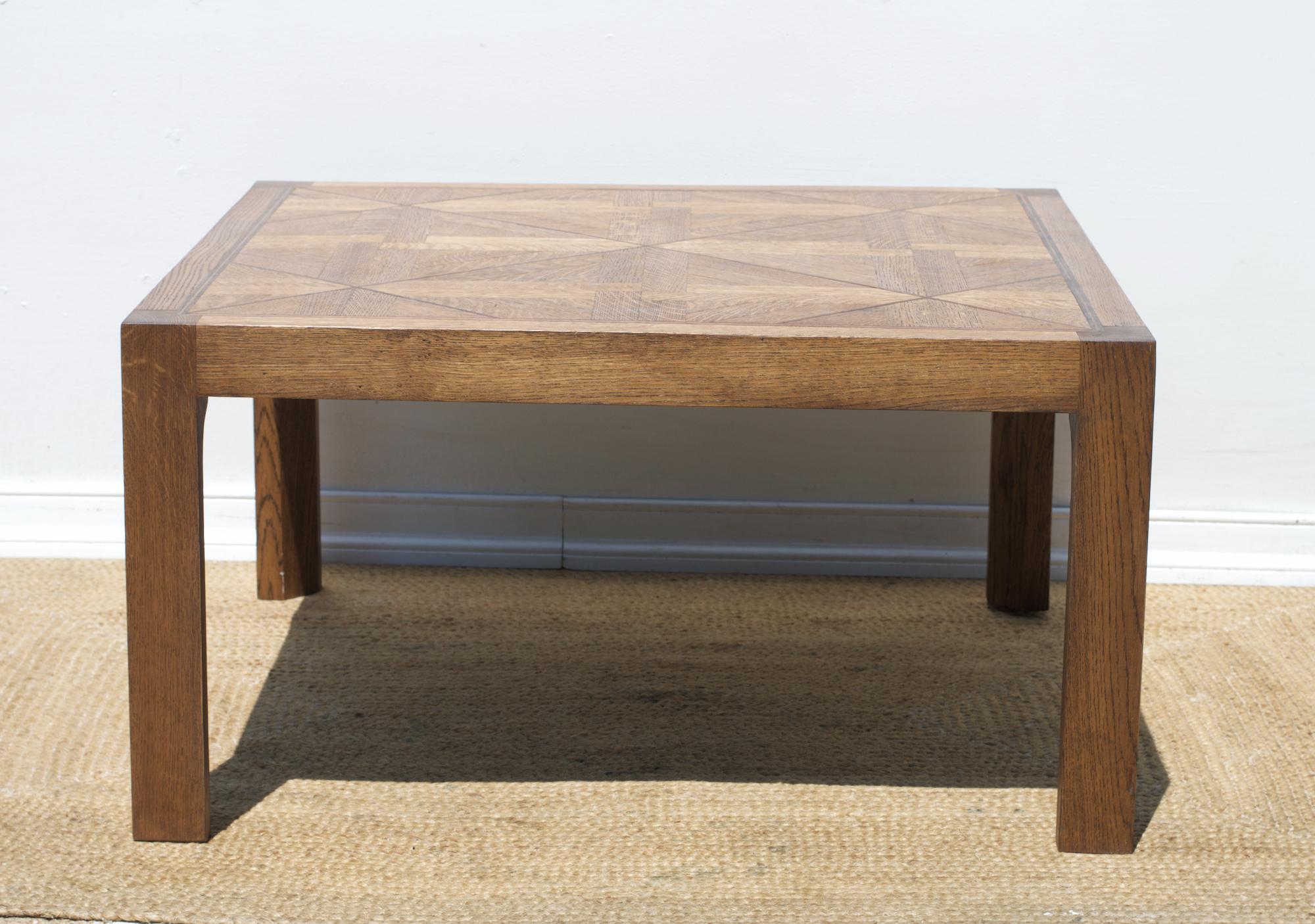 A chic and rustic parquet topped coffee table with chunky custom designed inverted lambs-tongue legs. The modern take on a French Provincial Classic look, this coffee table will employ well by the water, in the hills, in the lodge or in the city