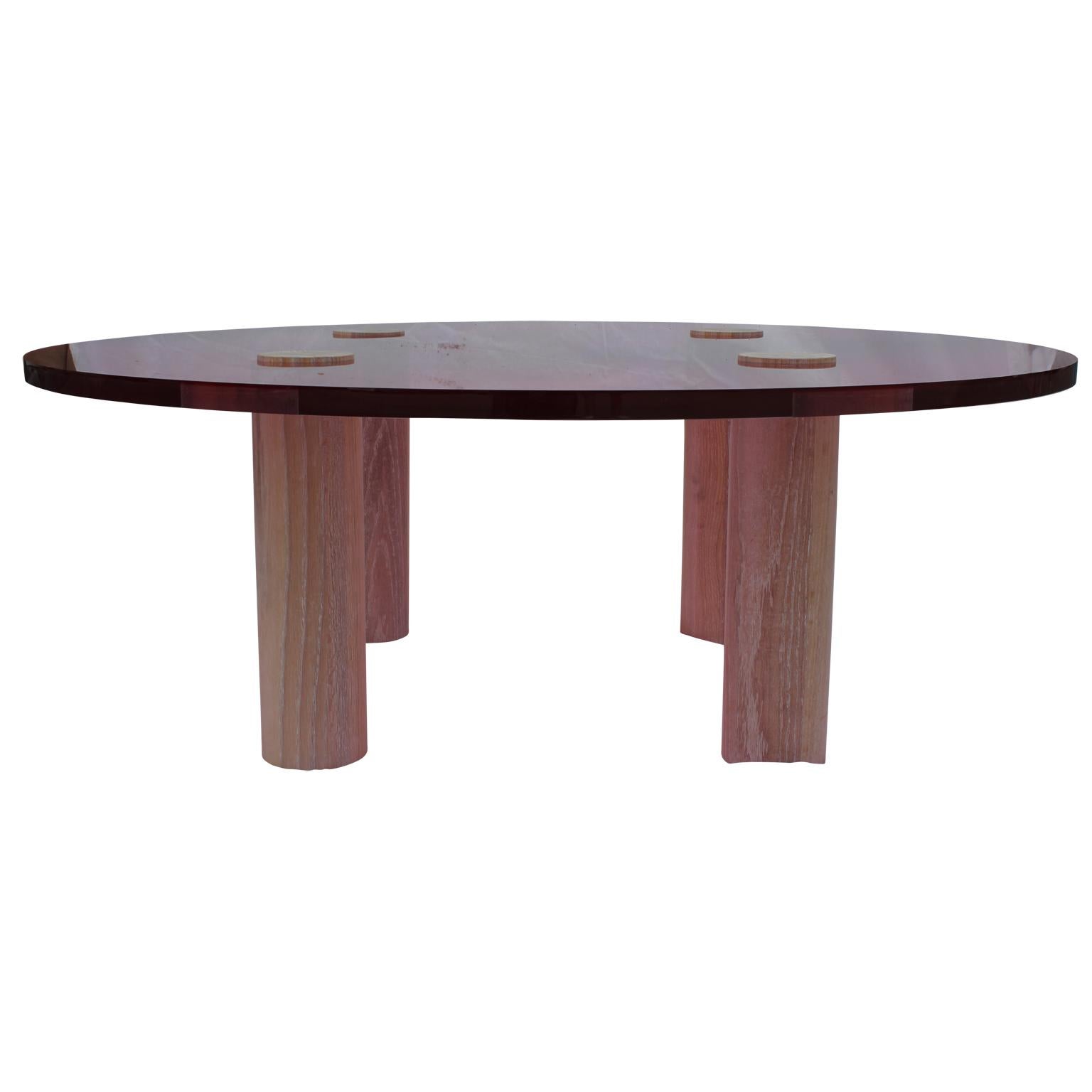 Reeves Art and Design custom made pink or rose Lucite table in a bold modern style. The table has four white oak legs with a white cerused finish. This table can be made in clear Lucite as well.