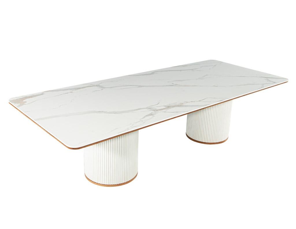 The Carrocel modern porcelain dining table is the perfect addition to any dining room. Crafted in Italy, this exquisite table brings a unique and modern look to your home. The table features cylindrical tambour pedestals with natural oak accent