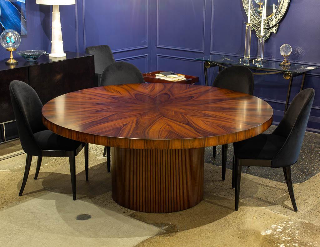 Custom Modern round dining table in Sunburst Pattern. Magnificent hand-crafted sunburst patterned top with modern round fluted base. Finished in a rich warm walnut color tone in a satin sheen for maximum durability and longevity. All hand crafted