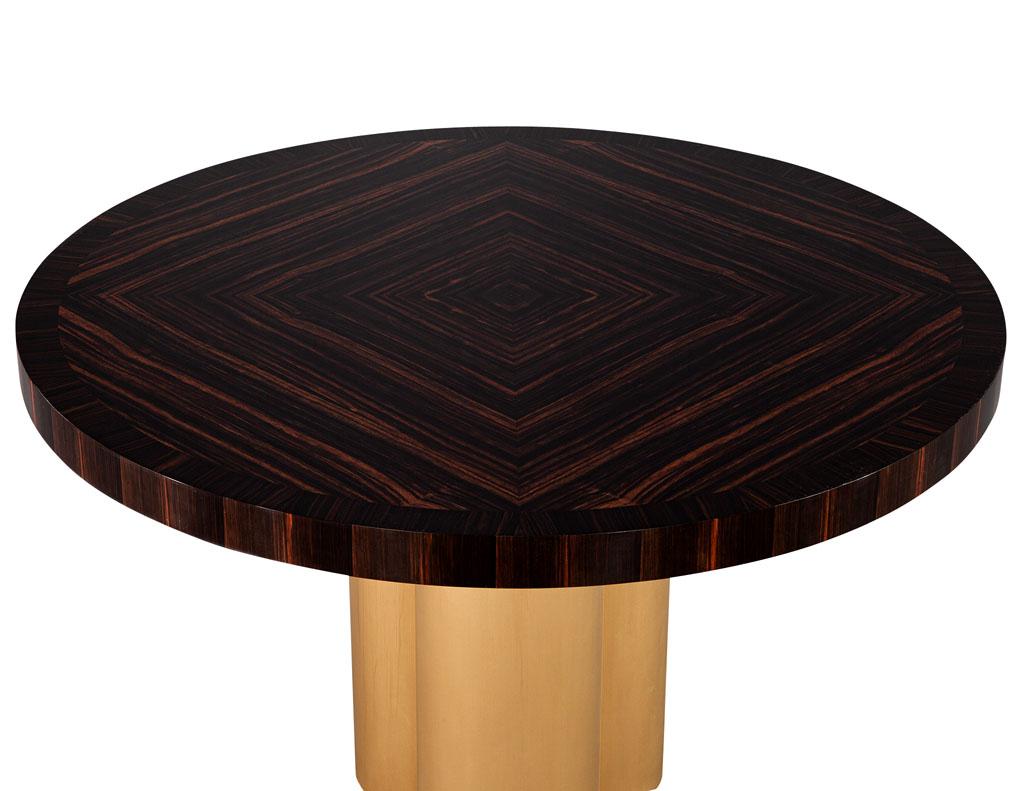 Custom Modern round Macassar Foyer dining table by Carrocel. Beautiful round Macassar top with unique wood grain inlay pattern. Resting on light antique brass clover base. The perfect table for an entranceway or cozy eating area. Price includes