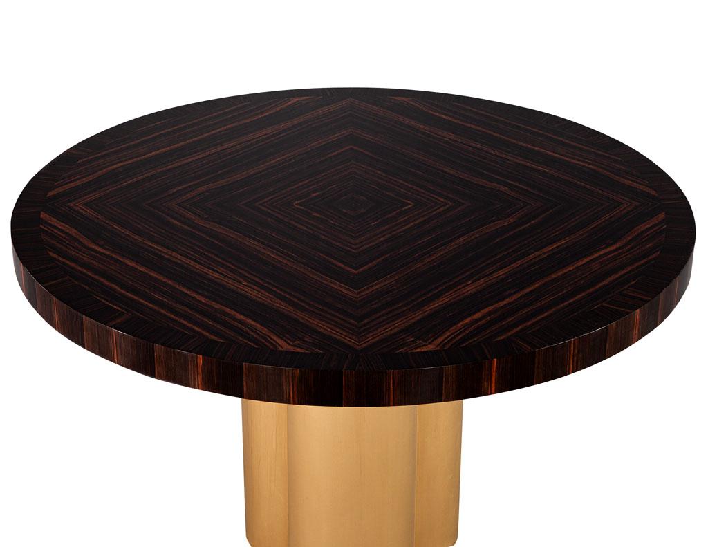 Custom Modern round Macassar Foyer dining table by Carrocel. Beautiful round Macassar top with unique wood grain inlay pattern. Resting on light antique brass clover base. The perfect table for an entranceway or cozy eating area. Price includes