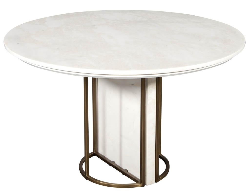 Custom modern round marble-top dining table with brass detailing. Stunning Carrocel custom made dining table with Namibian white stone perched above a geometric stone and brass base.

Price includes complimentary scheduled curb side delivery