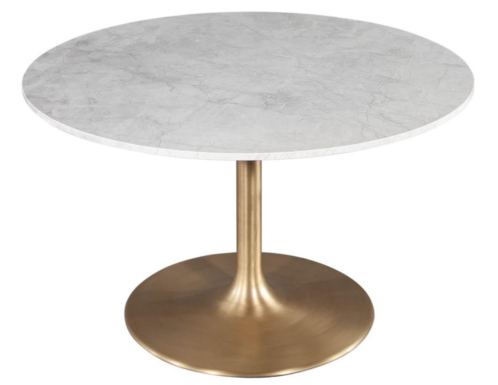 Custom Modern round stone top table with brass tulip base. Beautiful Italian stone top with luxurious light grey veining. Resting on top a sleek sculpted brass tulip base. The perfect table for an entrance or breakfast area. Price includes