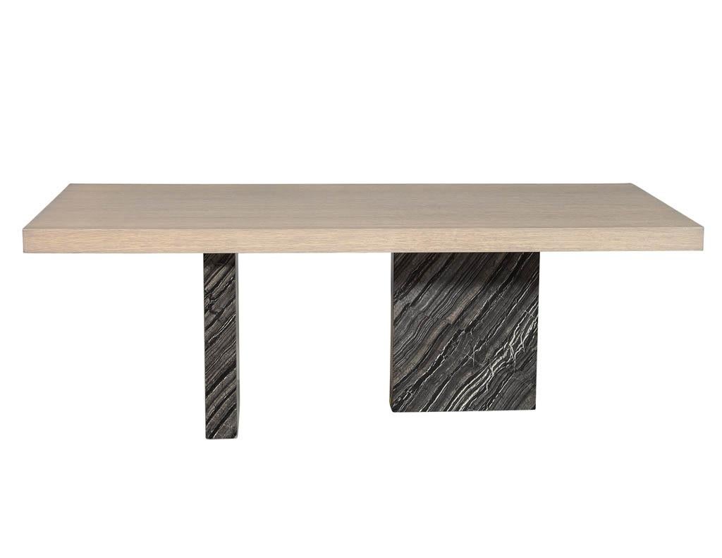 Carrocel custom designed and built modern dining table with an acid wash flat cut oak top with clean cut edges sitting on top of two diametrically opposed marble pedestal columns. Perfect for dining rooms or a slick office setting.

Price includes