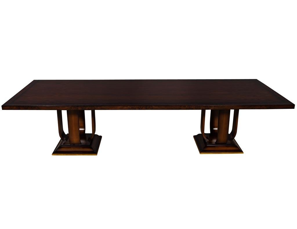 Custom modern walnut dining table Art Deco inspired. This handcrafted custom table is built and finished by our master craftsmen. It features an original Art Deco pedestal design with gold leaf accenting. With an absolutely gorgeous tabletop