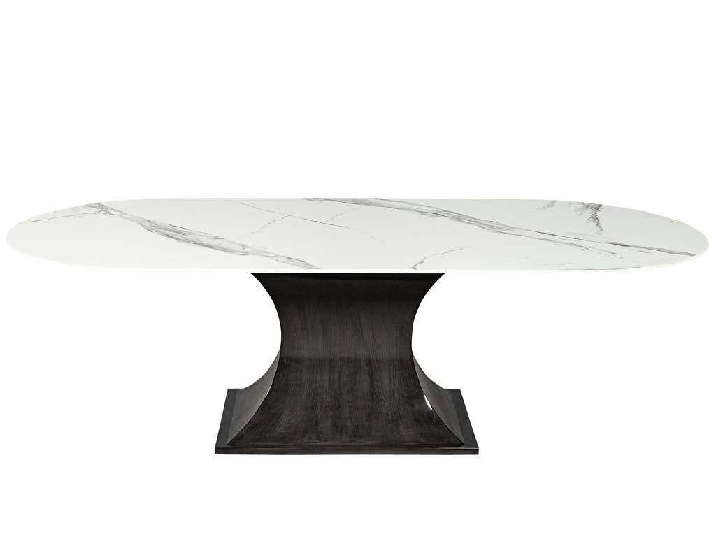 Custom modern white porcelain dining table by Carrocel. This gorgeous table has a solid white Calacatta porcelain top with grey veining. Perched on top of sleek modern grey polished base. The perfect table for a modern and sophisticated home.
Price
