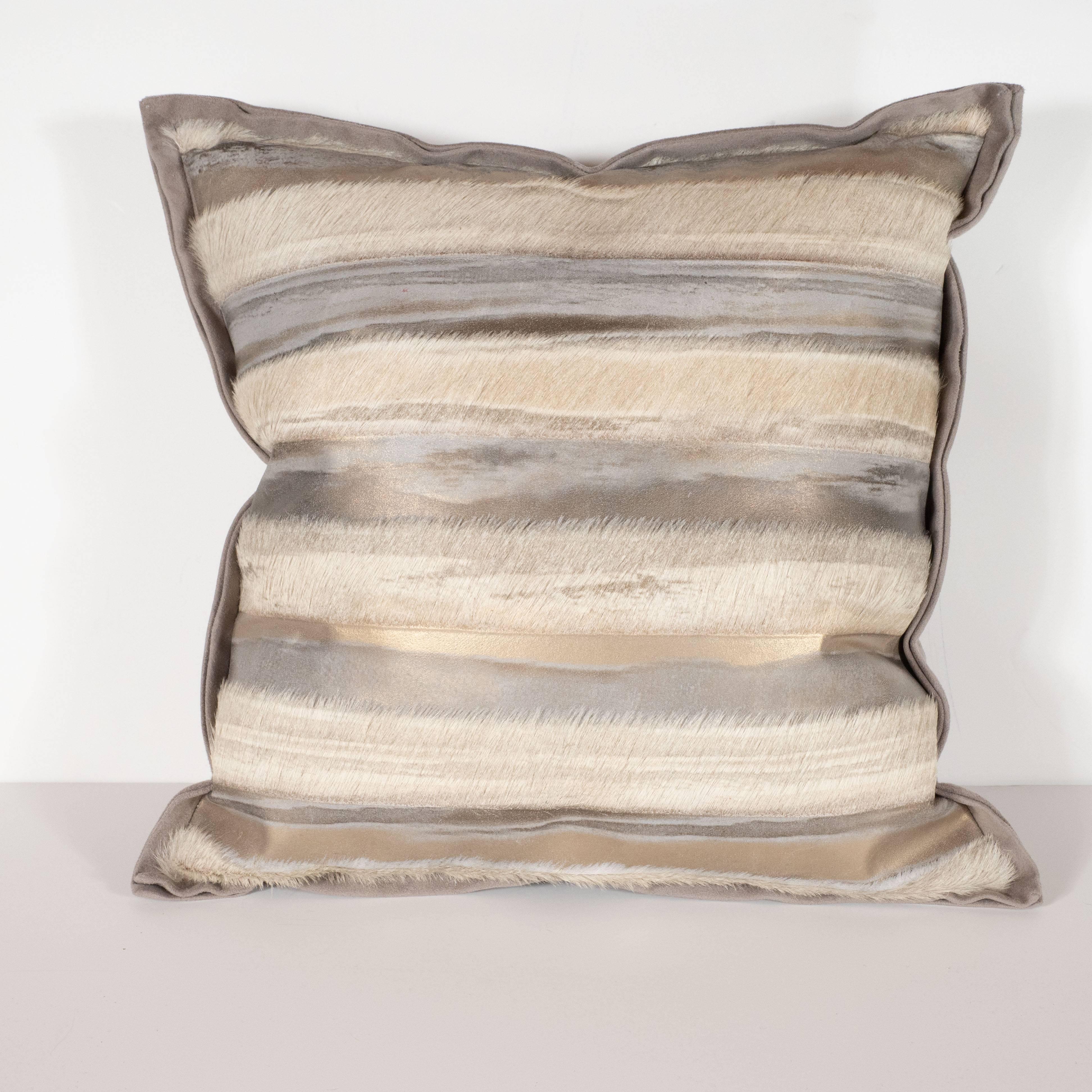 This sophisticated pair of hand-crafted modernist pillows were custom made by artisans in New York State. They feature alternating bands of off-white horsehide and iridescent lavender with yellow gold and antique pewter accents as well as a dove