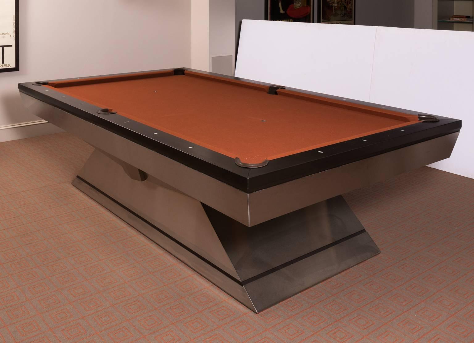 Custom-made monarch pool table that features Walnut rails with brushed stainless steel frame. Full rack included.