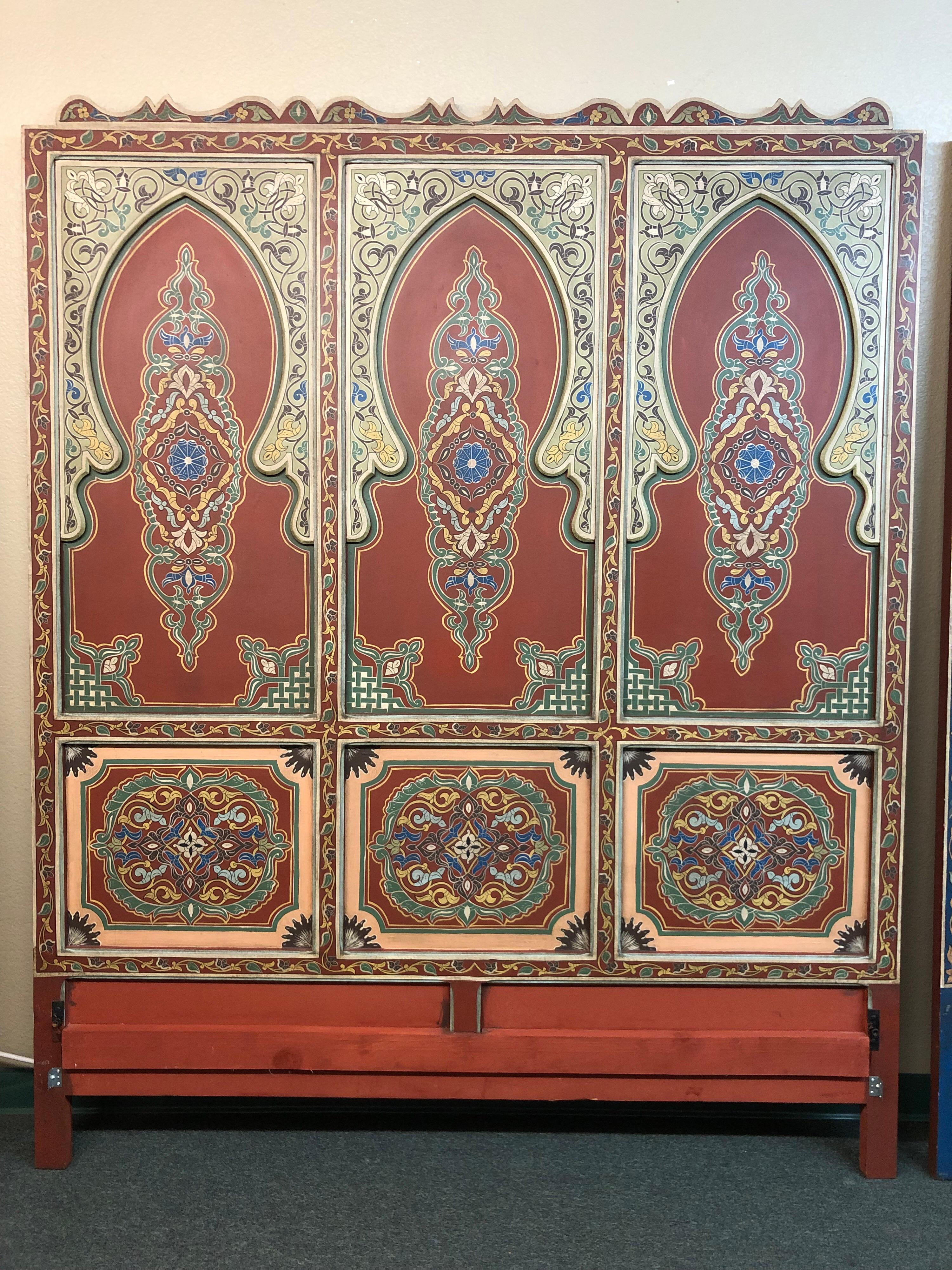 Stunning custom bedroom set, handcrafted in Morocco. Referencing traditional carved elements and rich colors of the country, the queen bed frame and pair of nightstands are an exotic delight that transports one to another time and place. Three