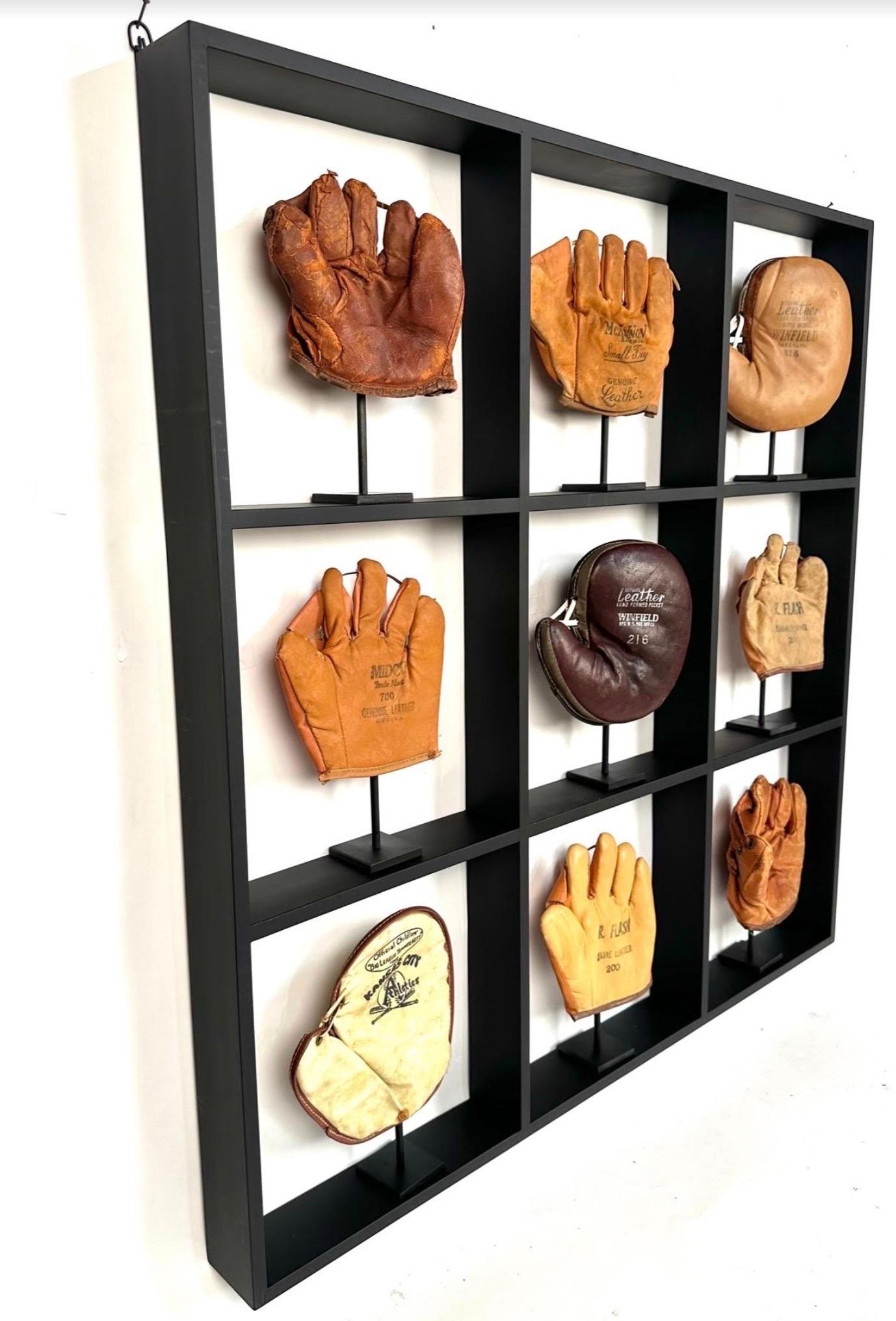 A collection of 9 rare small antique childs baseball gloves circa 1920's -1960's. Custom displayed in a cabinet grade black painted maple shadow box with custom made steel stands. 
The display measures 32
