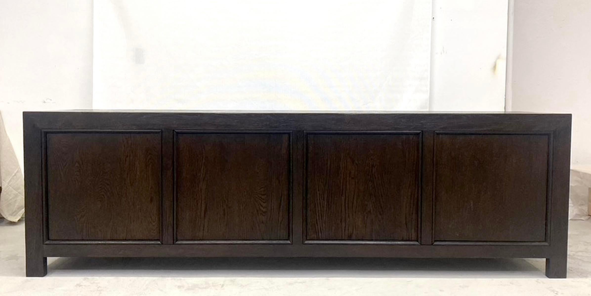 This is our custom Bola cabinet in oak with a dark, ebony finish with wood grain showing. This piece can be made in any size and finish. This specific piece was finished with an open grain and heavy distress. Doors push to open. Solid Oak. The lead