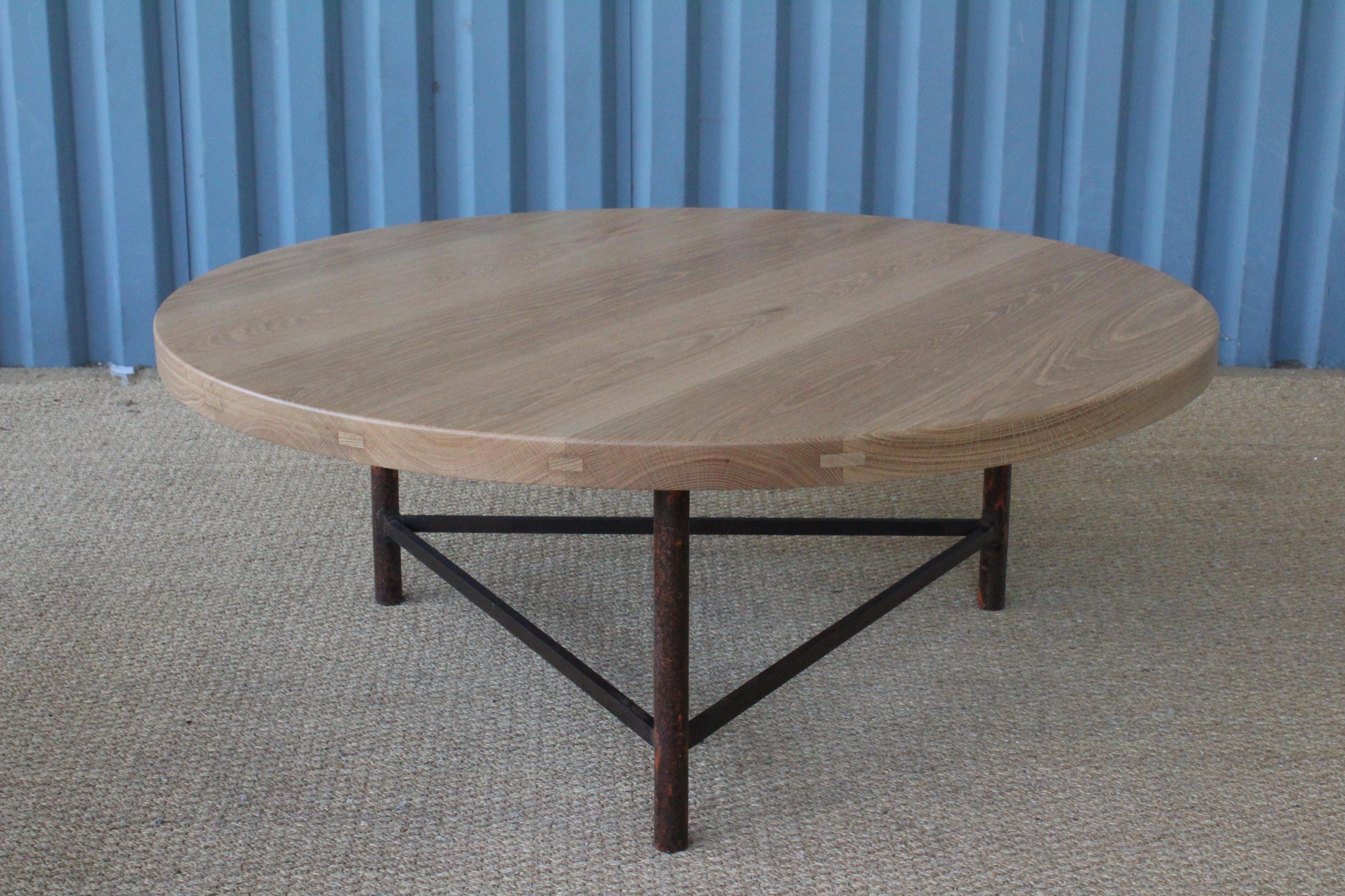 Custom solid white oak coffee table fitted onto a vintage iron base. Oak top has a natural finish while the iron base has plenty of patina.