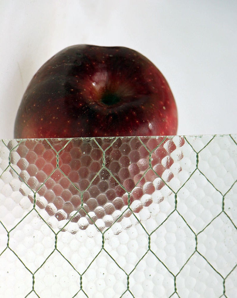1920s 'Pebbled' vintage chicken wire glass. All of our chicken wire glass is salvaged from old factory windows and doors. Sizes may be limited. Chicken wire glass comes in a variety of textures: 'clear', 'pebbled', 'hammered', 'wormy' and 'ribbed'.