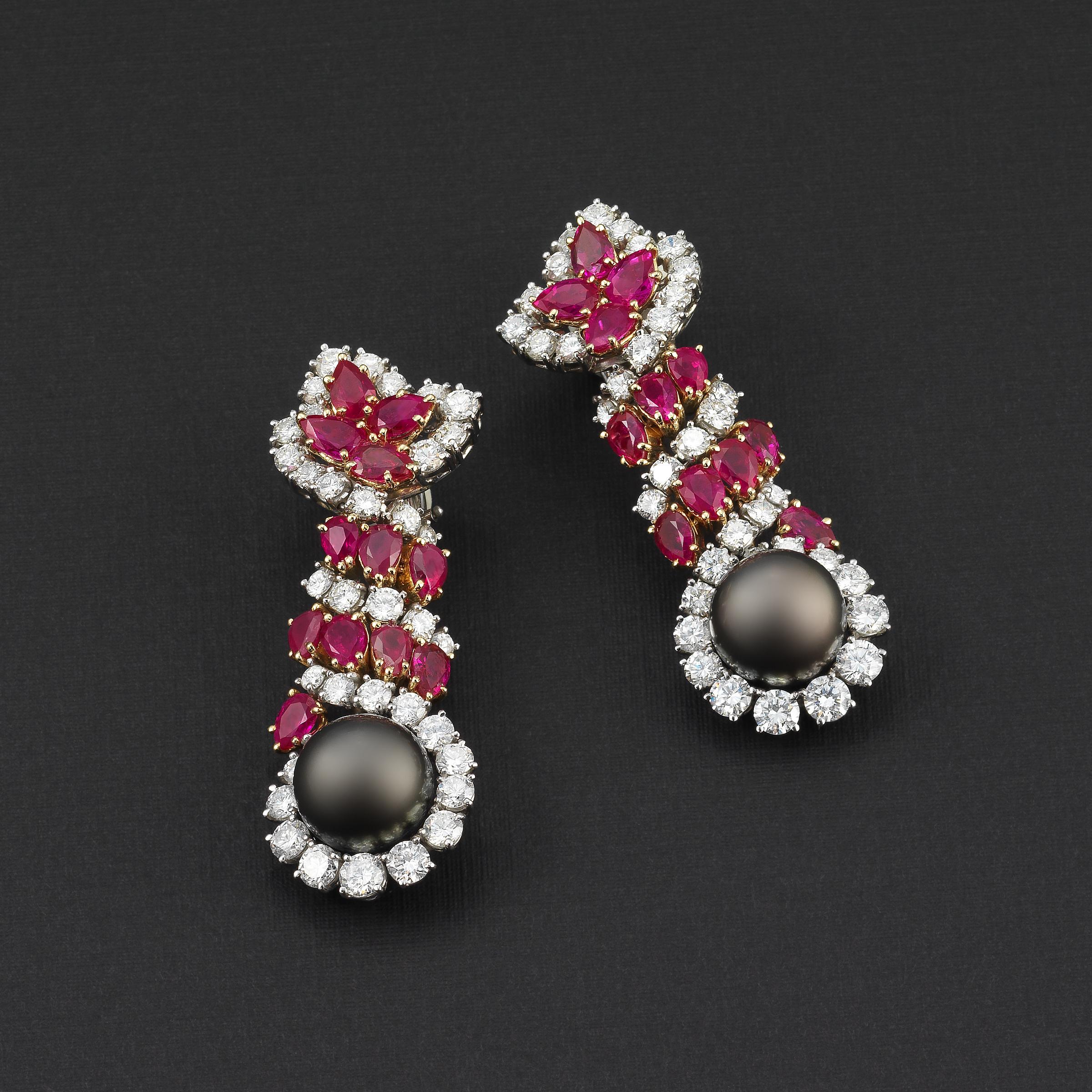 Harry Winston one-of-a-kind earrings and ring radiating 1970s glamour and showcasing fine white diamonds and vivid red Burma no-heat rubies along with eye-catching round Tahitian black pearls that complete a bold design. 
Earrings details:
-