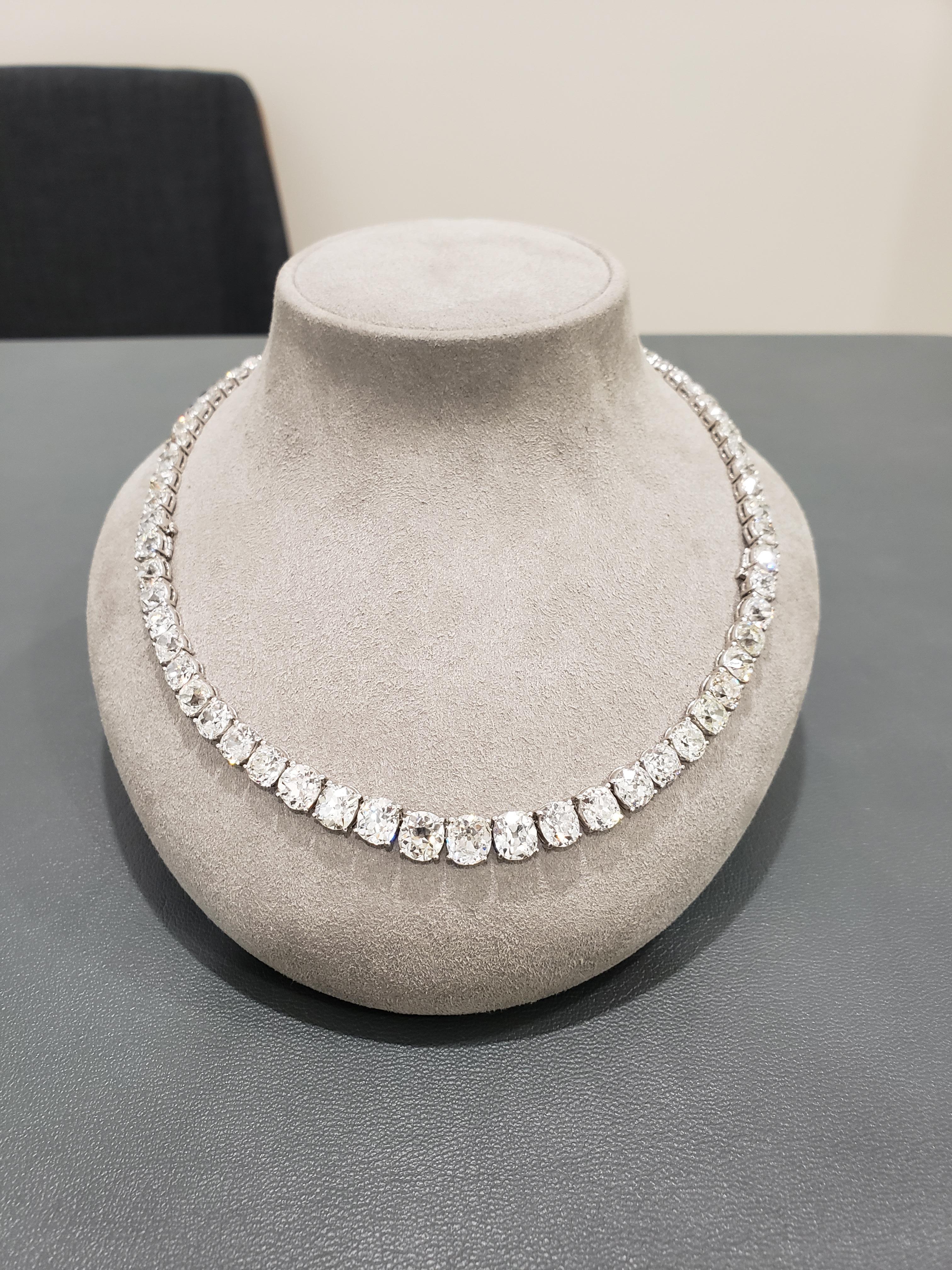 A custom made old mine cut diamond rivière platinum necklace, that is not eligible for return.

1.  The necklace will contain at minimum, 60-65 carats of natural diamonds set in platinum, 16.5 inches in length. The loose stones will be weighed and