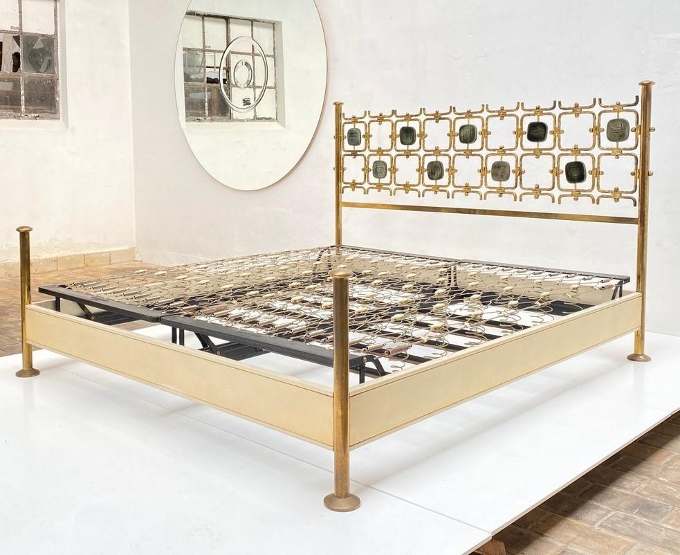 Beautiful and important brass bed  with nine sculptural relief panels  finihed in fired enamel . The  bed was designed  by Osvaldo Borsani in 1959 and and comes with a certificate of authencity from the Osvaldo Borsani archive confirming the date .